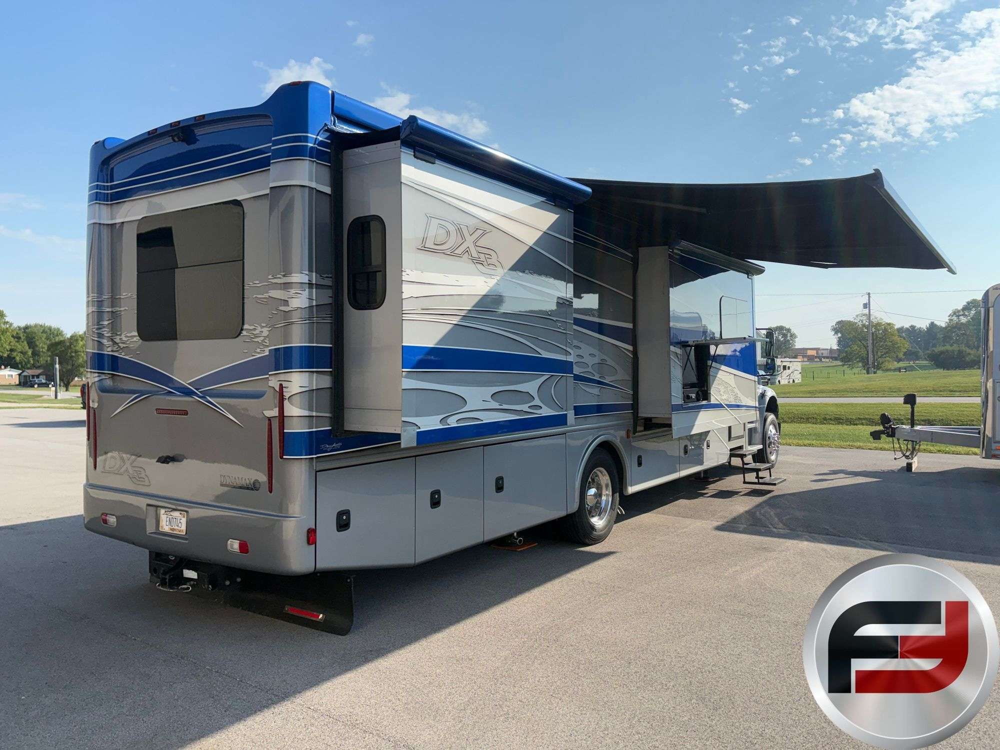 Rear quarter view of the 2017 Dynamax DX3 37TS with awning out