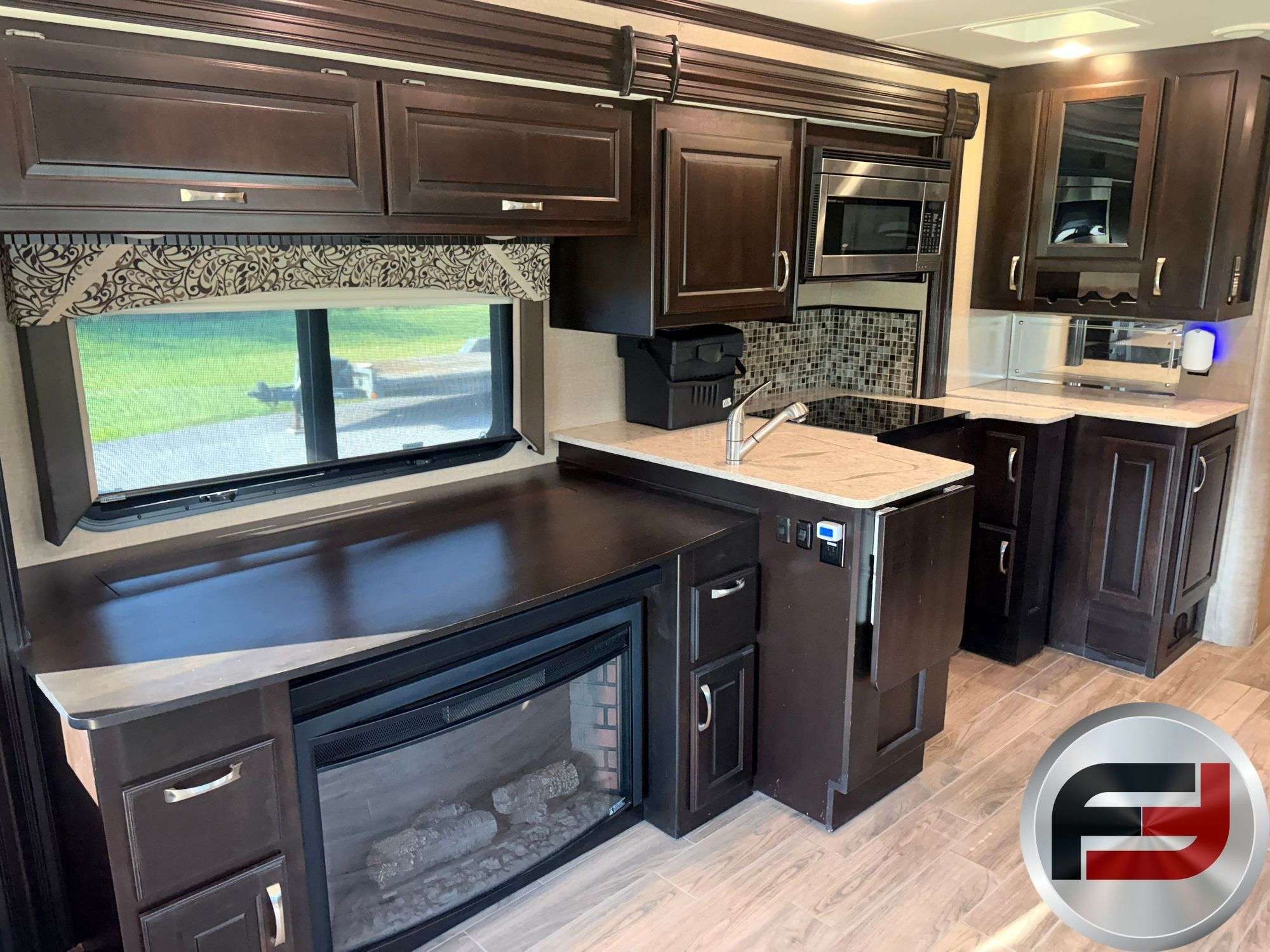 Kitchen and fireplace inside the 2017 Dynamax DX3 37TS