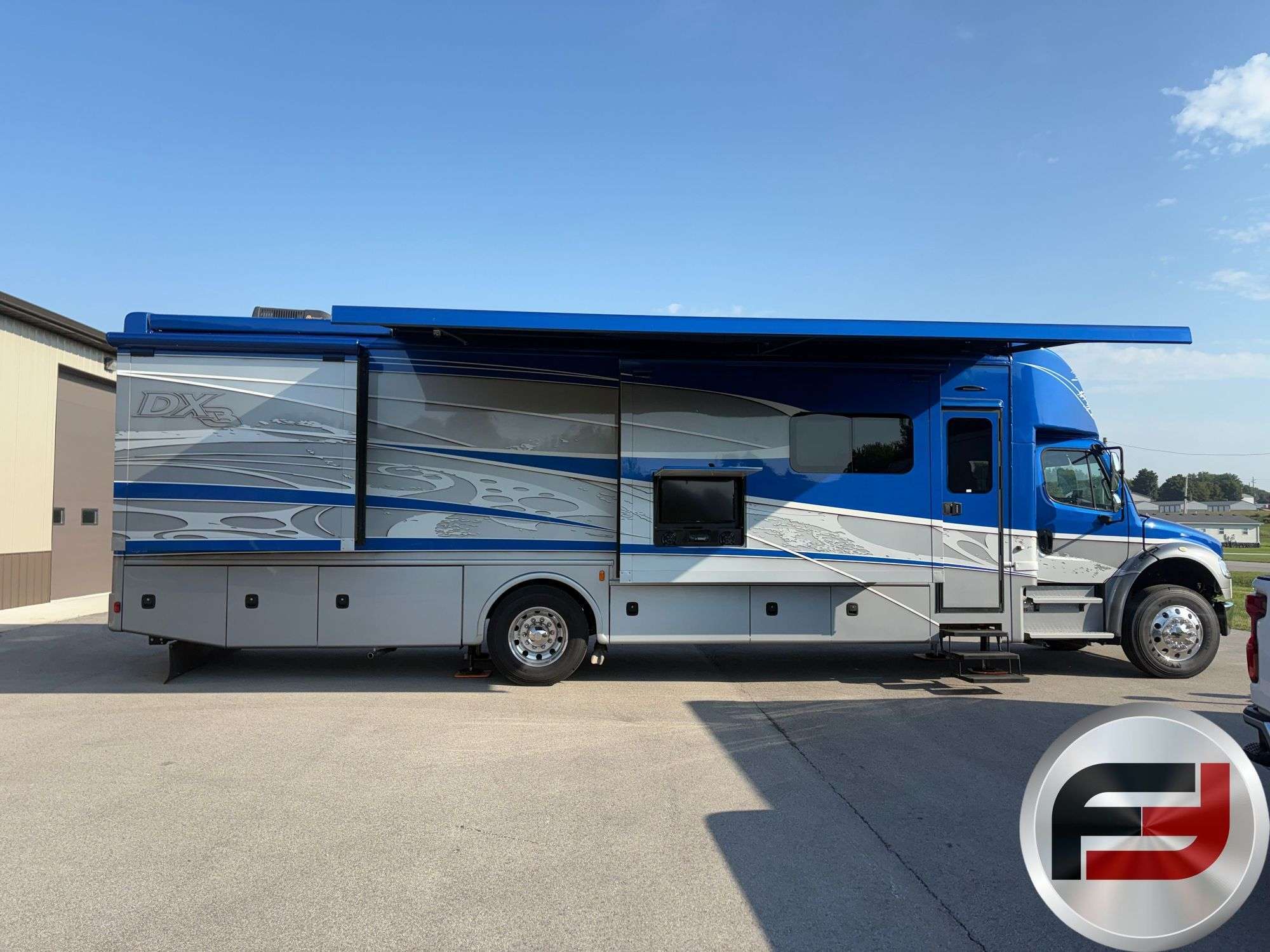 Driver-side profile of the 2017 Dynamax DX3 37TS with slide-outs and awning extended
