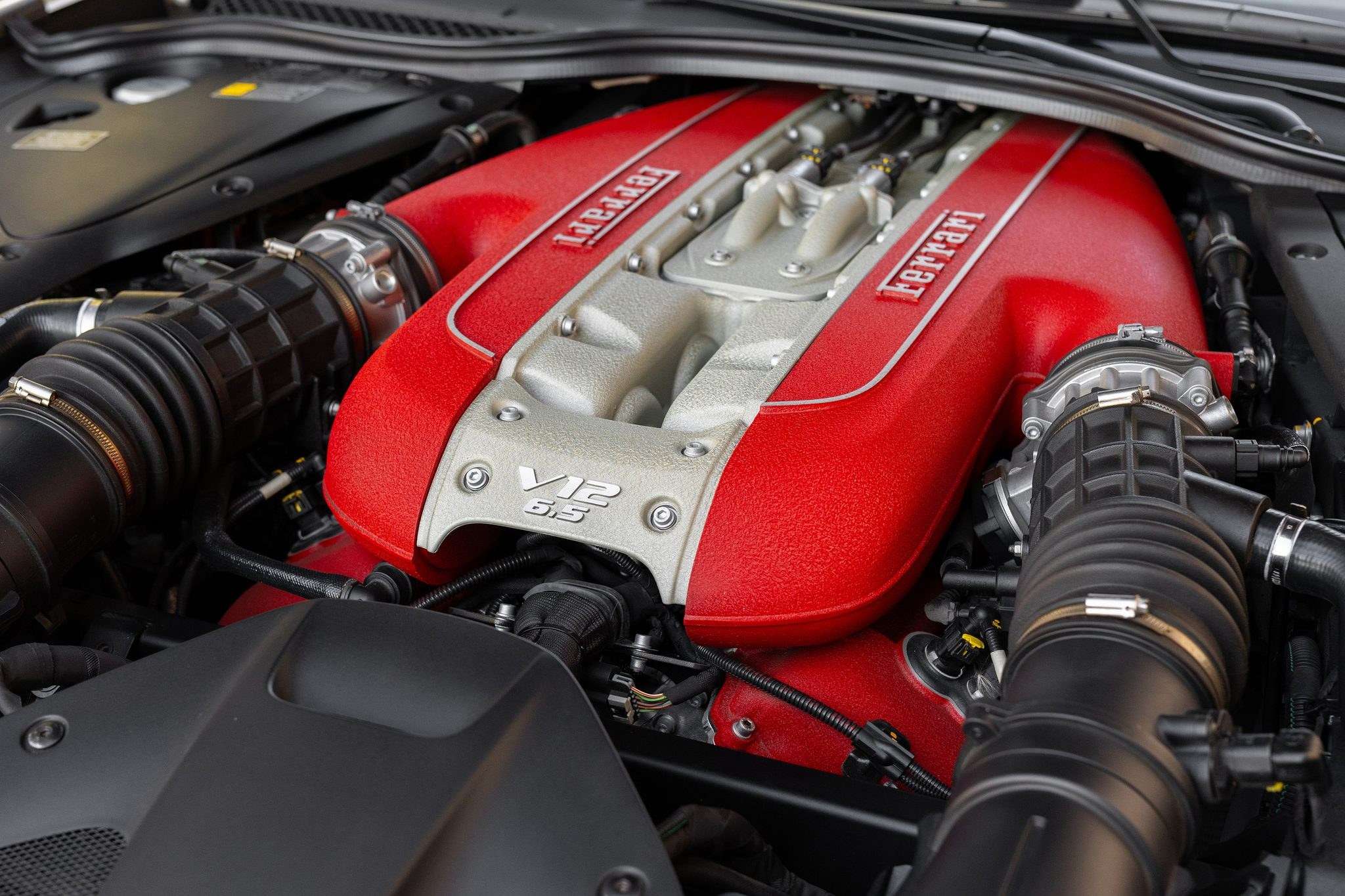 Red-painted Ferrari F140 6.5-liter V12 engine bay of the 812 GTS