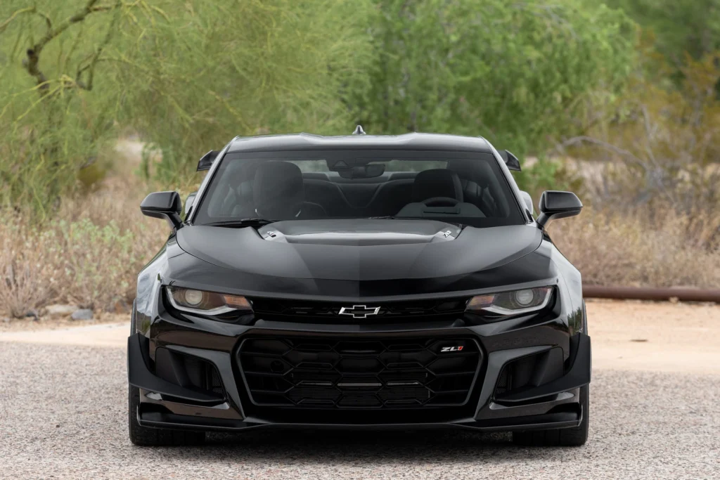 Front view of a black 2023 Camaro ZL1 1LE showing the splitter and dive planes