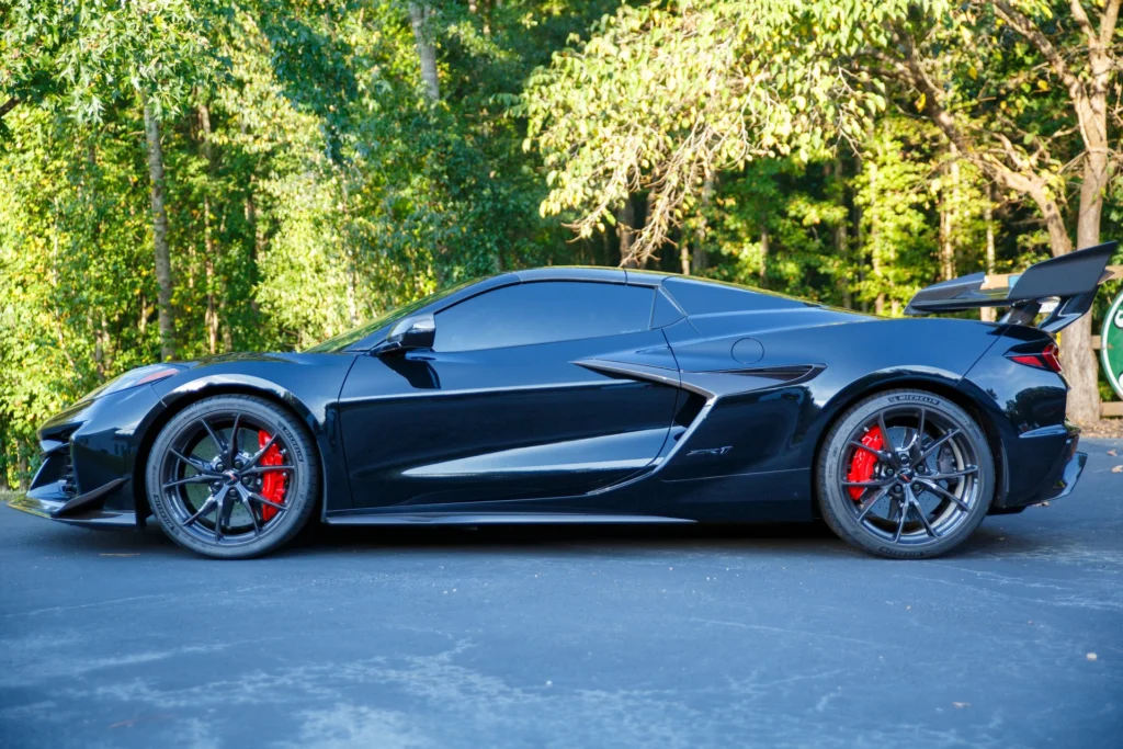 Side profile of the black 2026 Chevrolet Corvette ZR1 convertible with red brake calipers