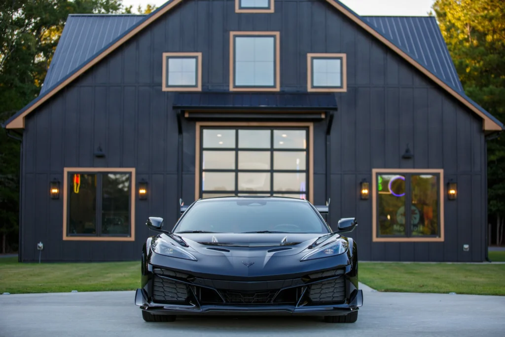Front view of the 2026 Chevrolet Corvette ZR1 parked in front of a dark barn
