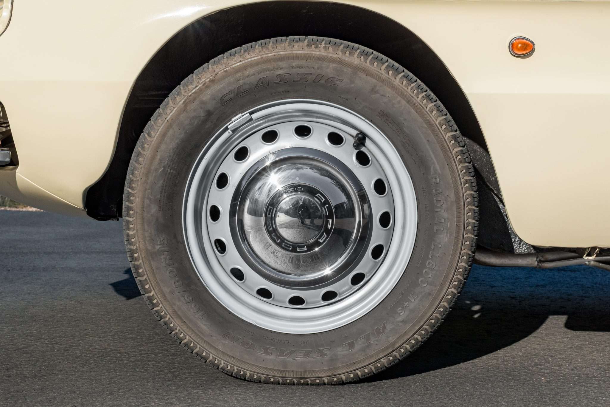 15-inch steel wheel with hubcap on a 1966 Alfa Romeo 1600 Spider