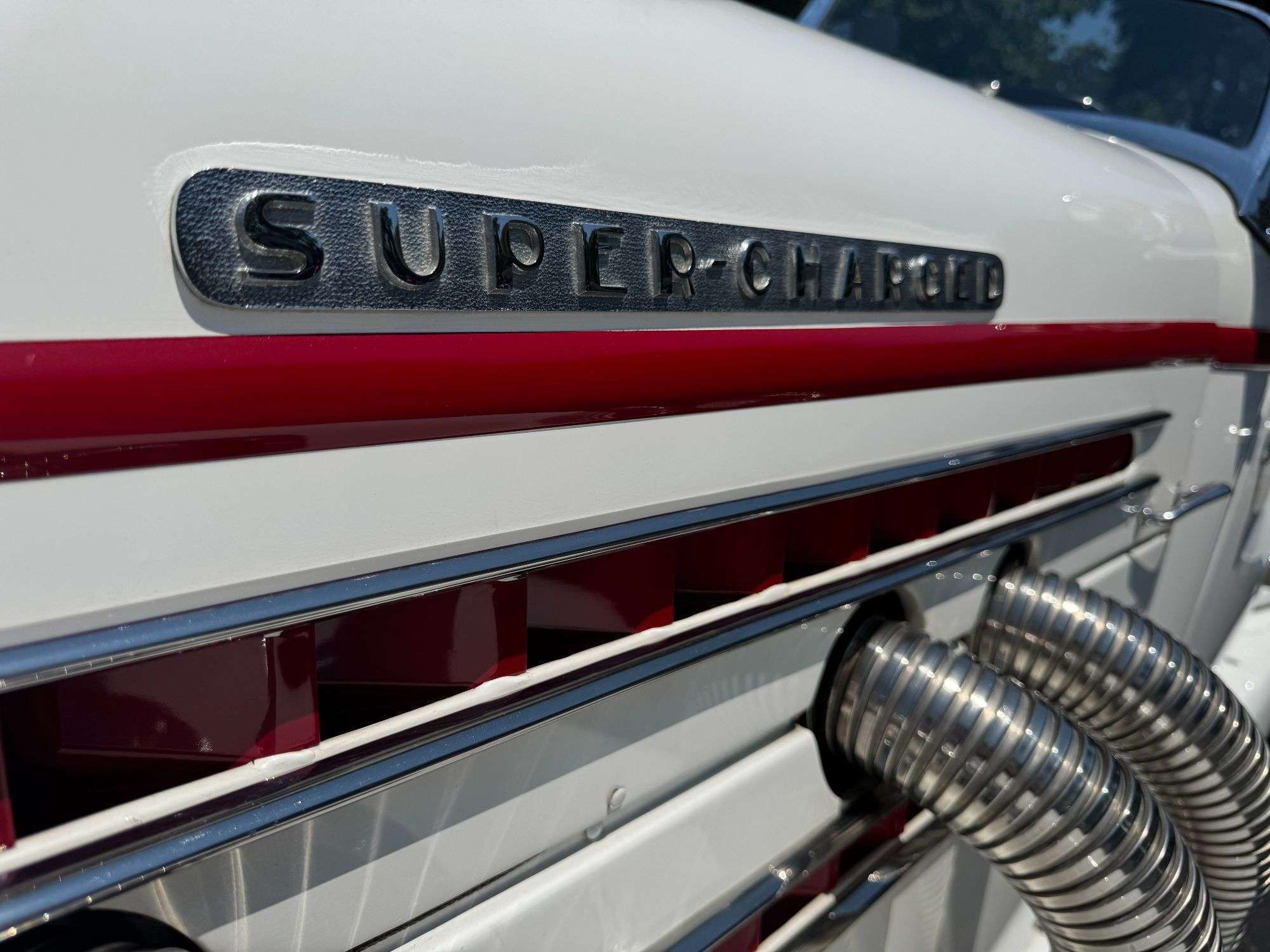 Supercharged script and chrome external exhaust pipes on the 1936 Auburn 852 Speedster