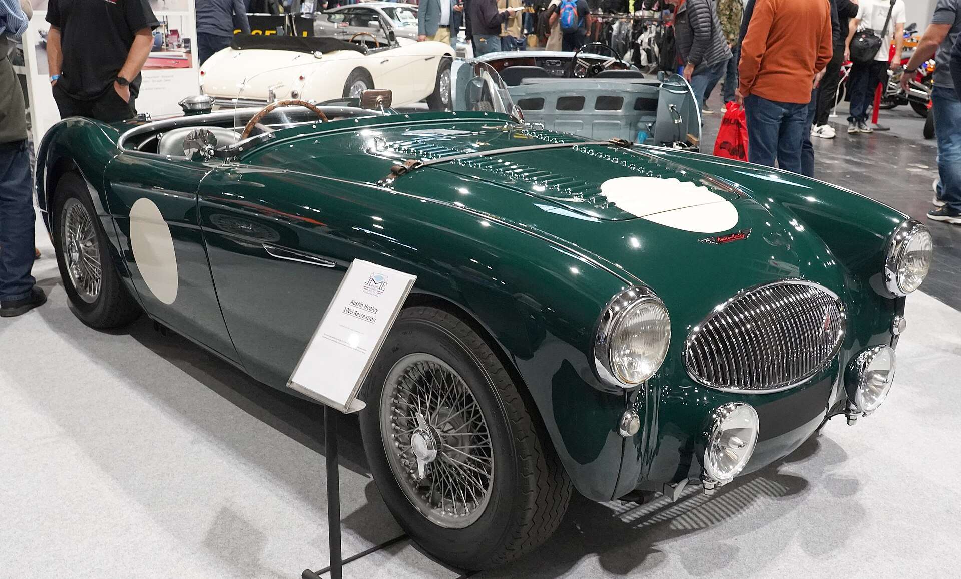 Dark green Austin-Healey 100S recreation with white roundels on the bonnet and side at the 2025 Classic Motor Show