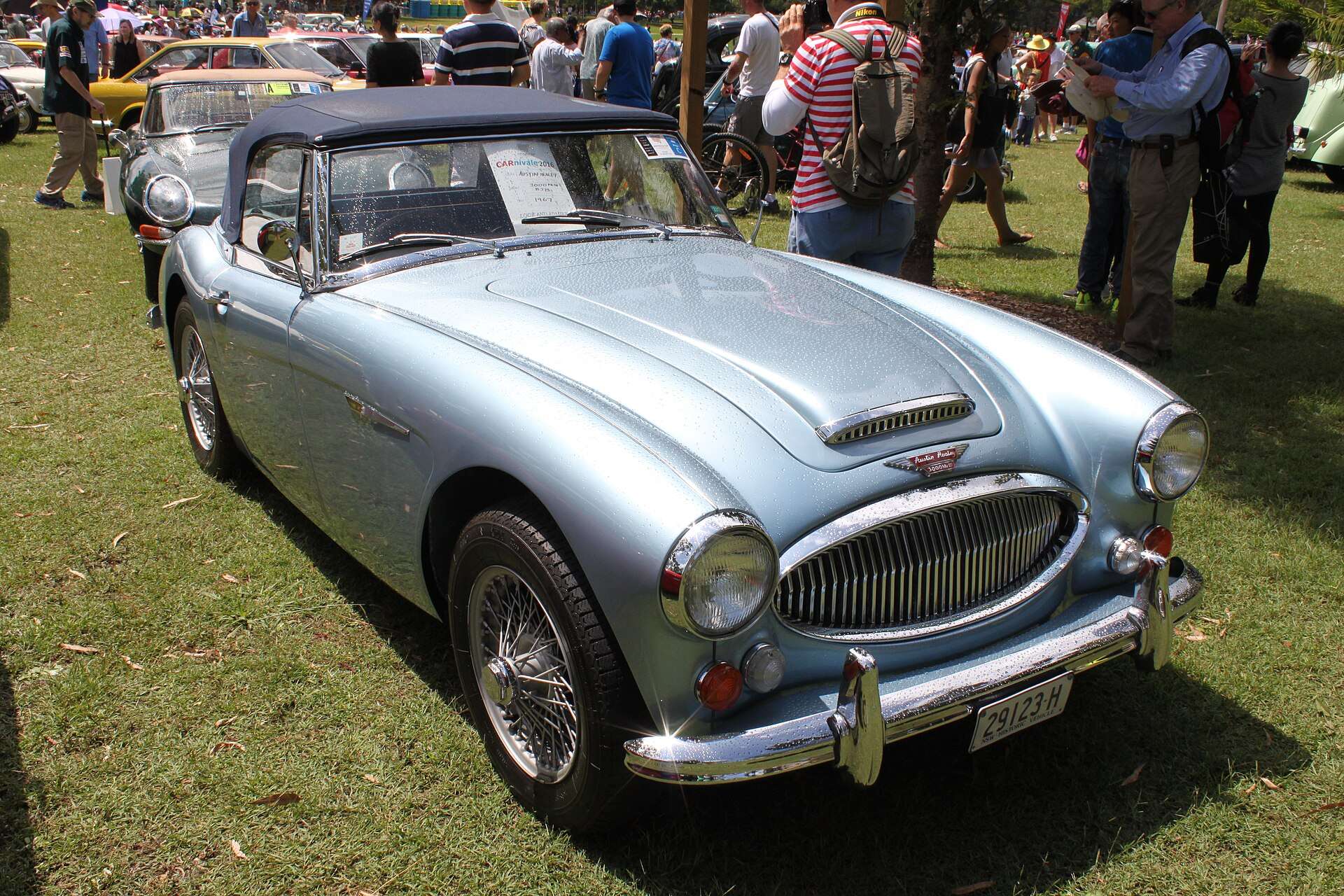 Silver-blue 1967 Austin-Healey 3000 Mk III BJ8 with chrome grille, wire wheels and soft top at a car show