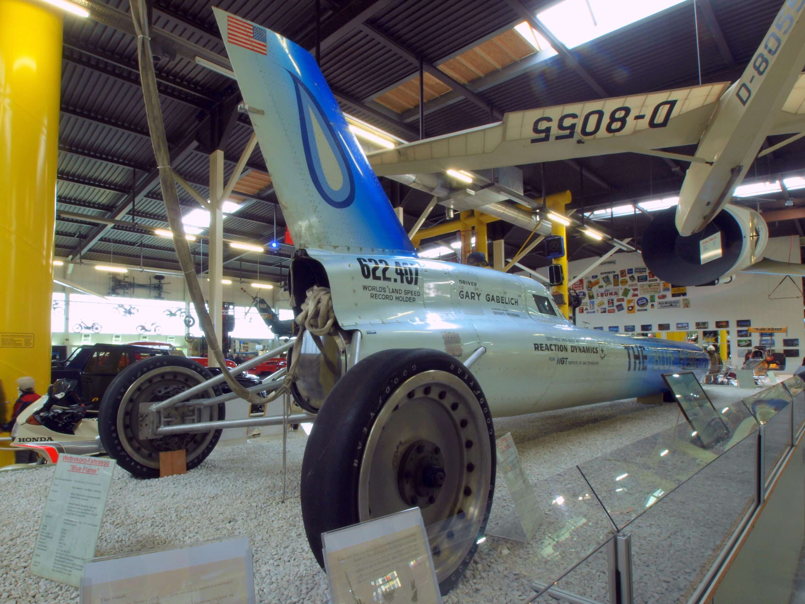 Tail section of the Blue Flame rocket car showing its stabilizing fin, rear wheel and the 622.407 record-speed lettering with Reaction Dynamics markings
