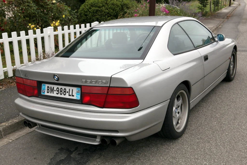 Rear view of a silver BMW 850CSi showing the 850 CSi trunk badge and four round exhaust tips