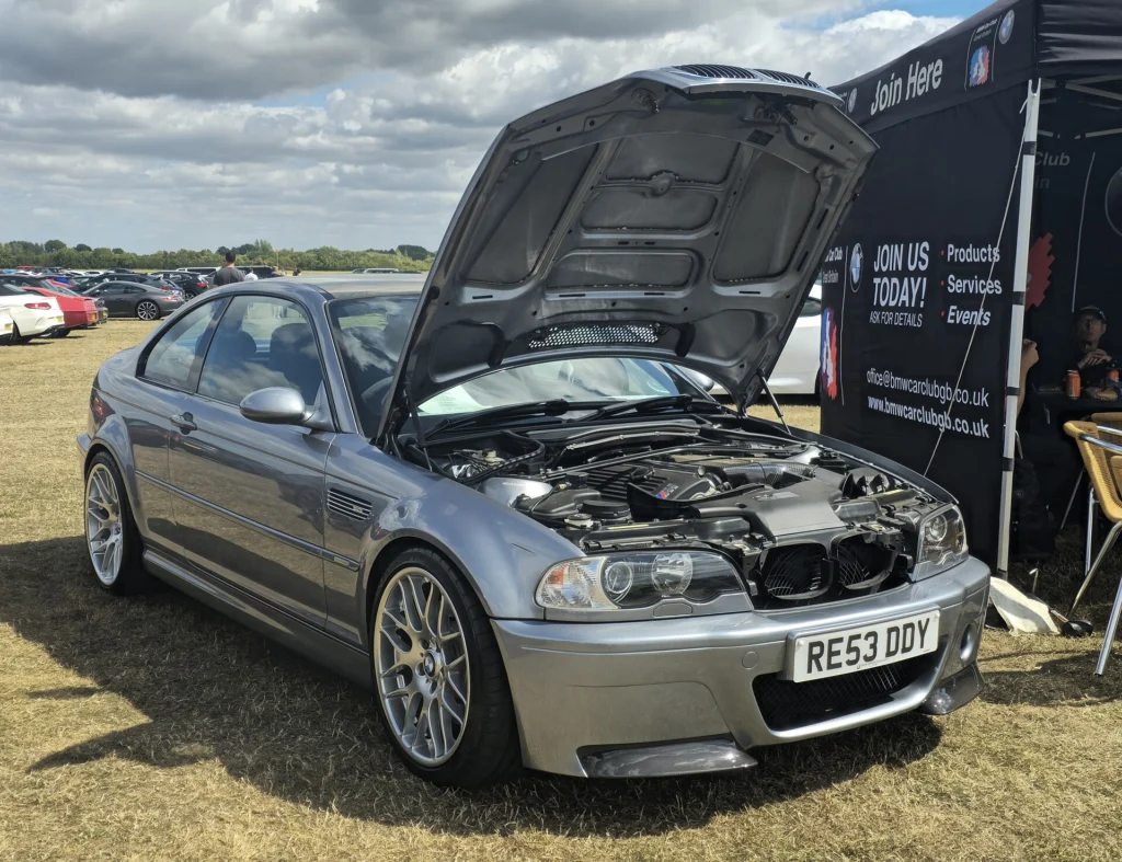 Grey 2003 BMW E46 M3 CSL with the bonnet raised, showing the S54 engine bay