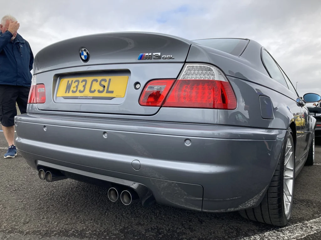 Rear of a grey BMW E46 M3 CSL showing the trunk lid, M3 CSL badge and quad exhaust tips