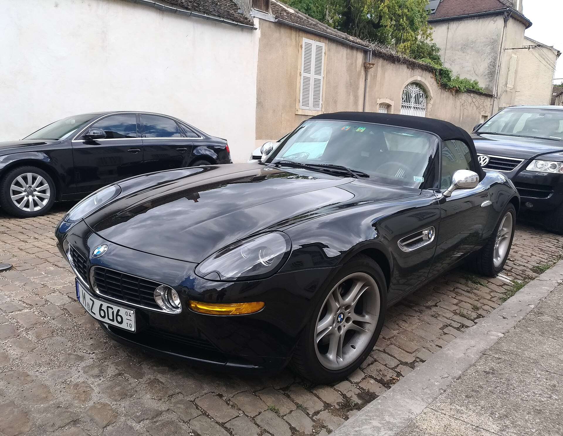 Black BMW Z8 with the soft top raised parked on a cobblestone street