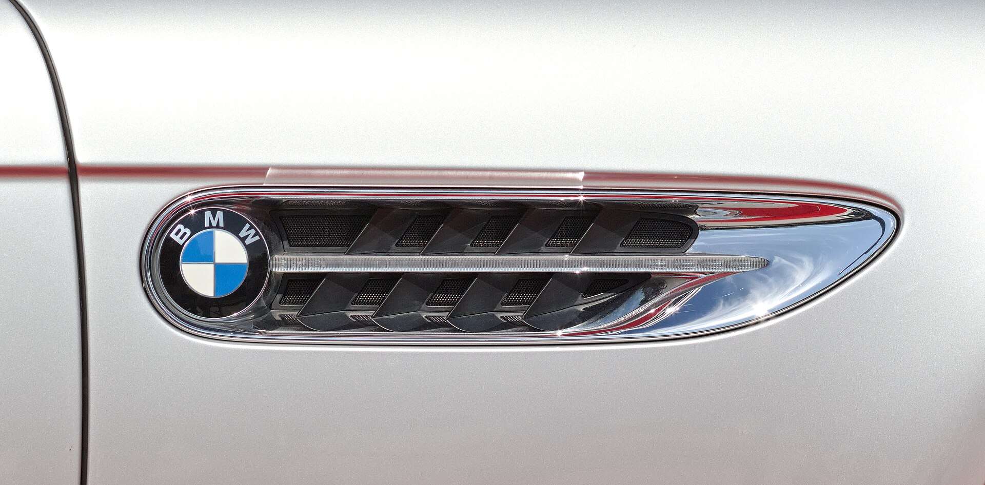 Close-up of the BMW Z8 chrome side fender vent with the BMW roundel