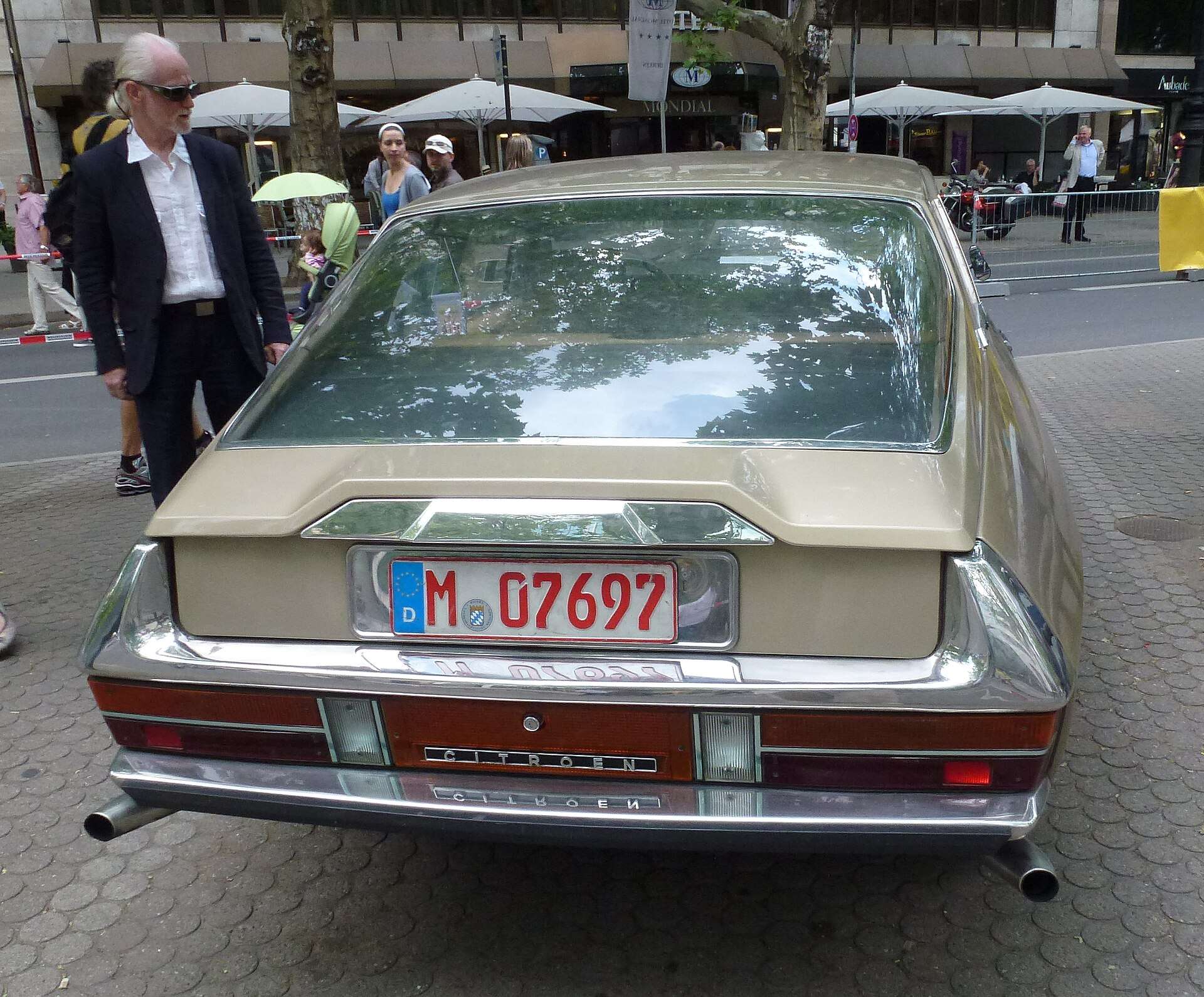 Rear view of a gold Citroën SM coupe with its tapered tail and recessed rear window