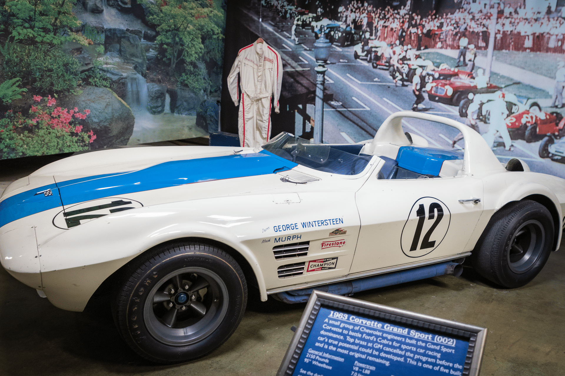 Side view of a 1963 Corvette Grand Sport race car with number 12 in a museum