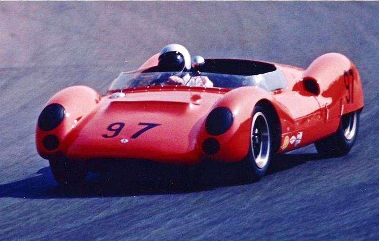 Dave MacDonald in a white helmet driving a red number 97 Cooper sports racer at Riverside in April 1964