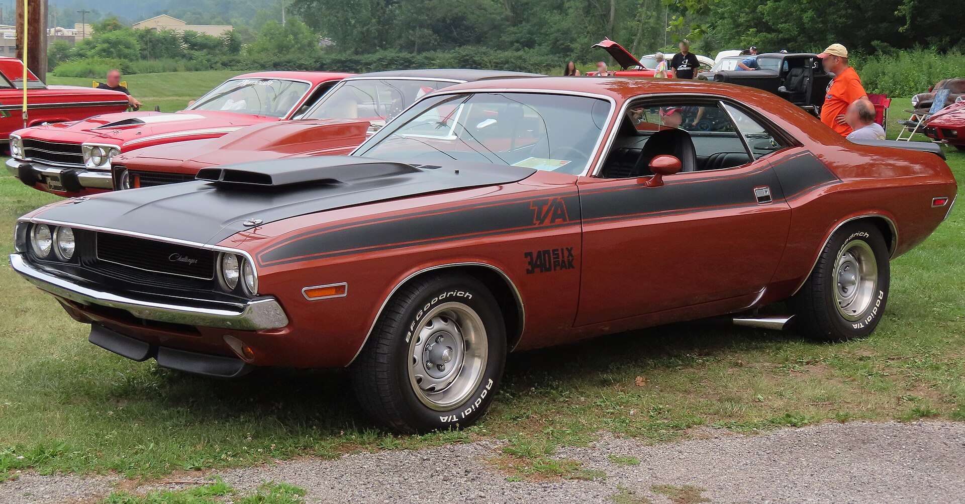 Copper-colored 1970 Dodge Challenger T/A with black hood and T/A stripes at a car cruise