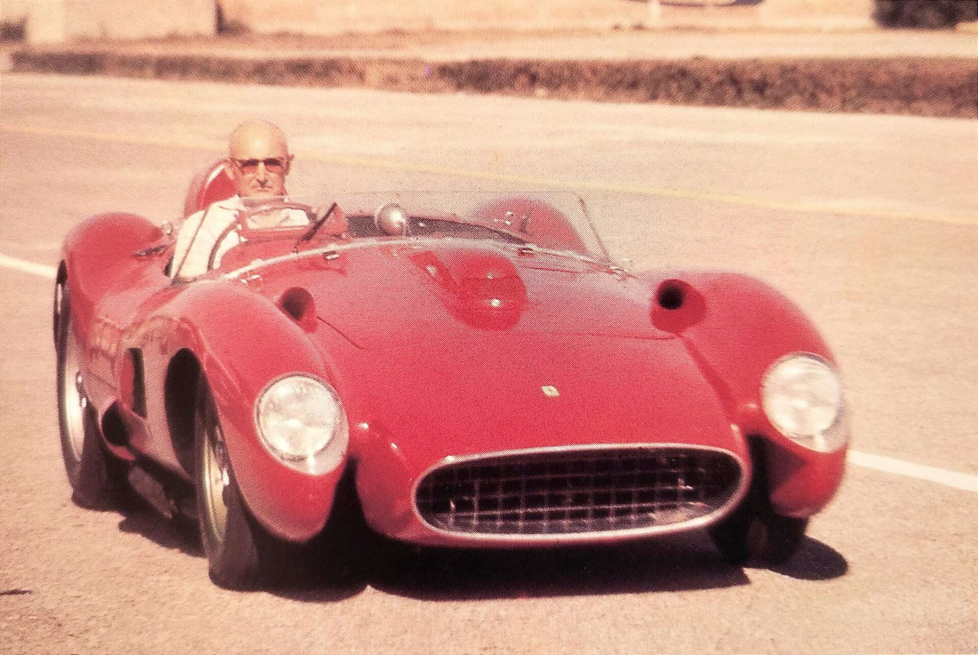 Luigi Bazzi seated in a Ferrari 335 in 1957