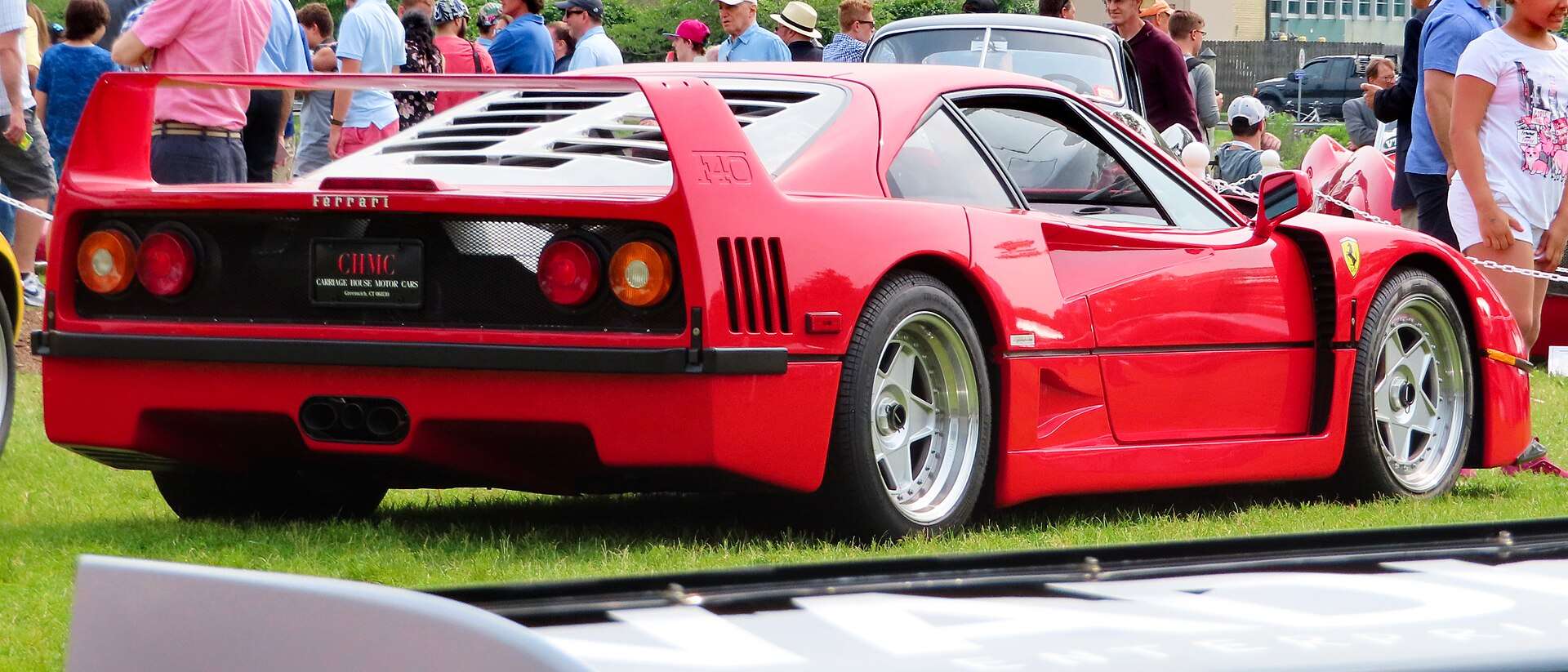 Rear view of a 1991 Ferrari F40 at a concours showing the engine cover and wing