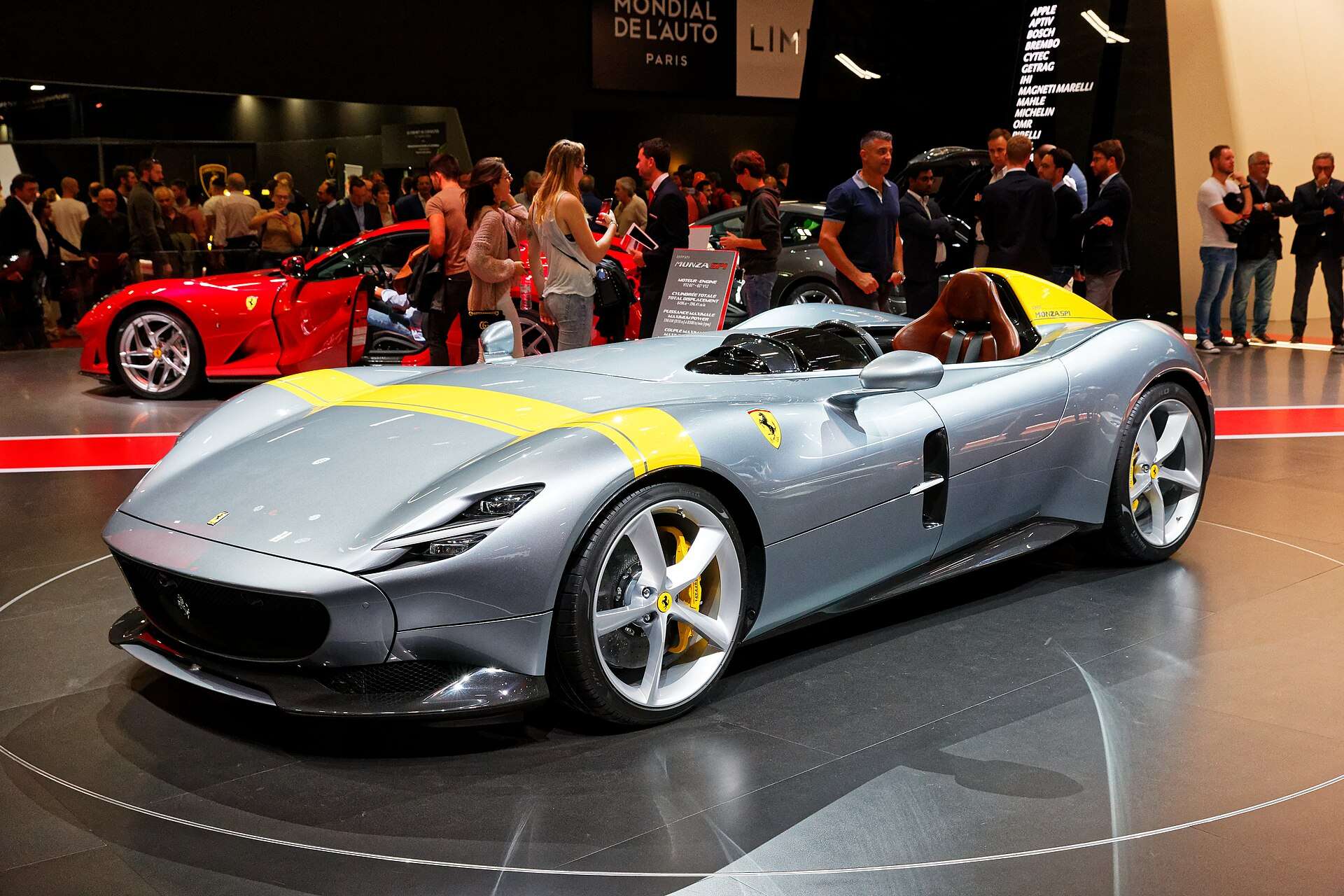Grey Ferrari Monza SP1 single-seat speedster with yellow stripe at the 2018 Paris Motor Show