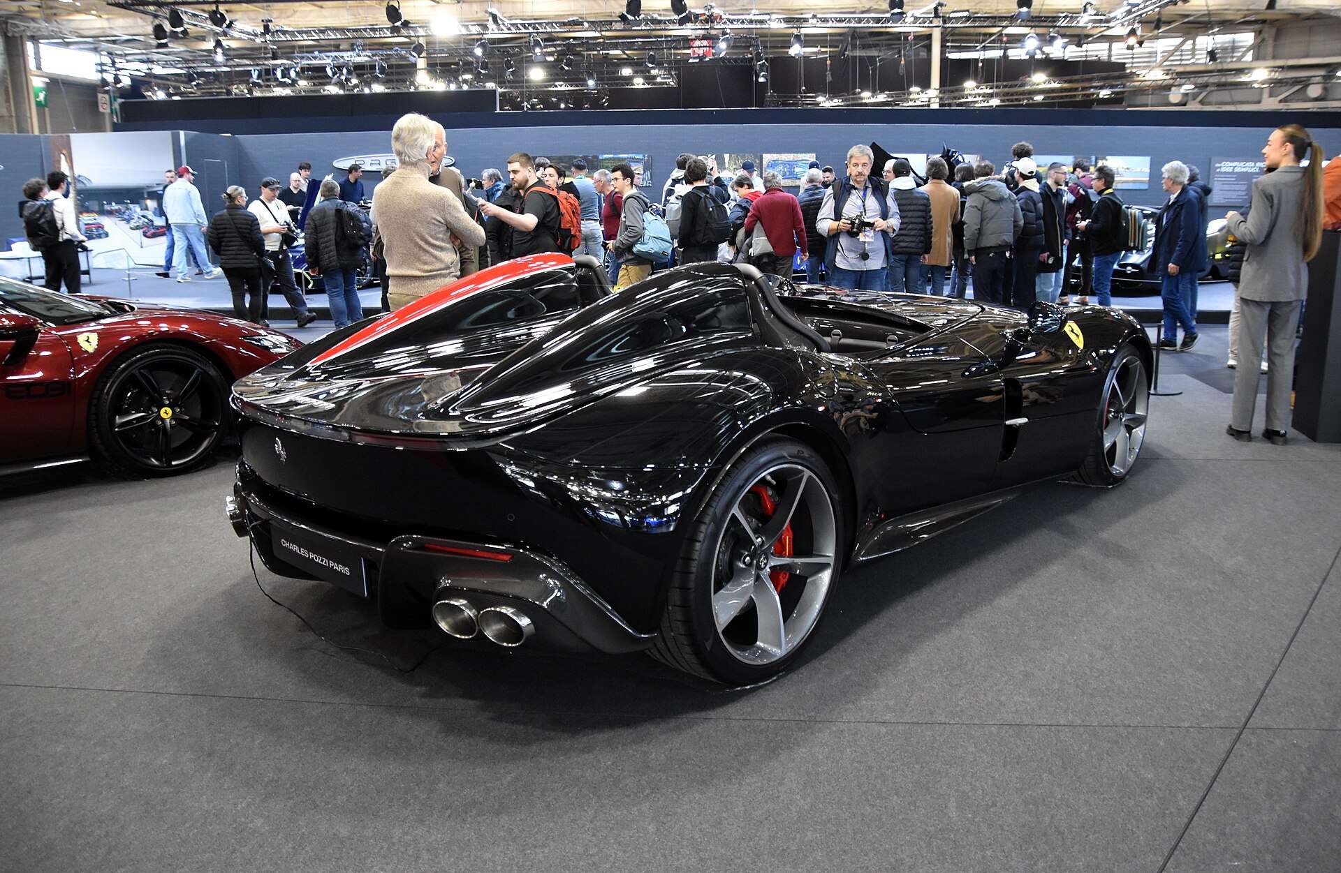 Black Ferrari Monza SP2 rear three-quarter view showing twin headrest fairings and quad exhausts