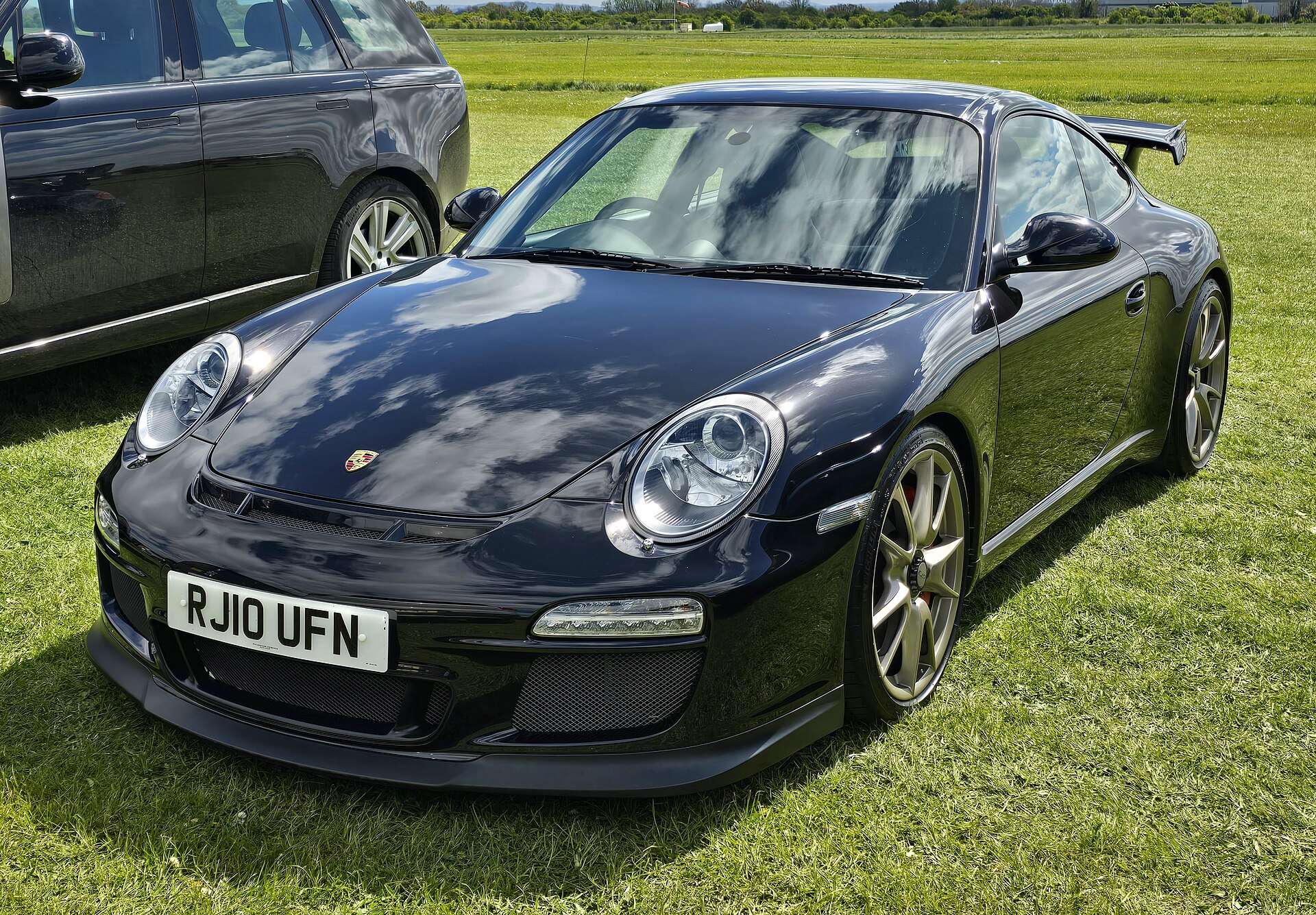 Rear three-quarter view of a 2010 Porsche 997.2 GT3 showing the fixed rear wing