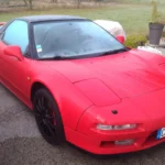 Ayrton Senna’s Honda NSX Heads to RM London. The Estimate Prices the Paperwork, Not the Car. Red first-generation Honda NSX parked, front three-quarter view