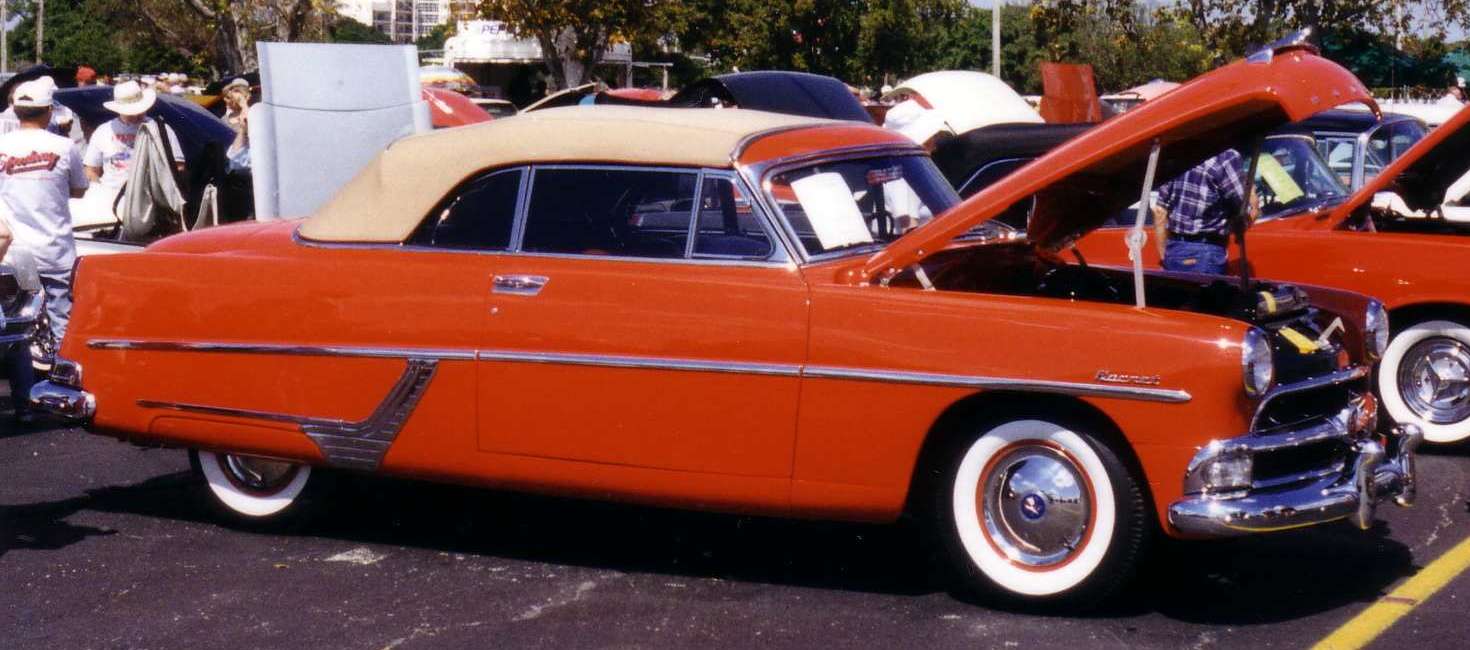 Red Hudson Hornet step-down convertible with top down at an AACA car show