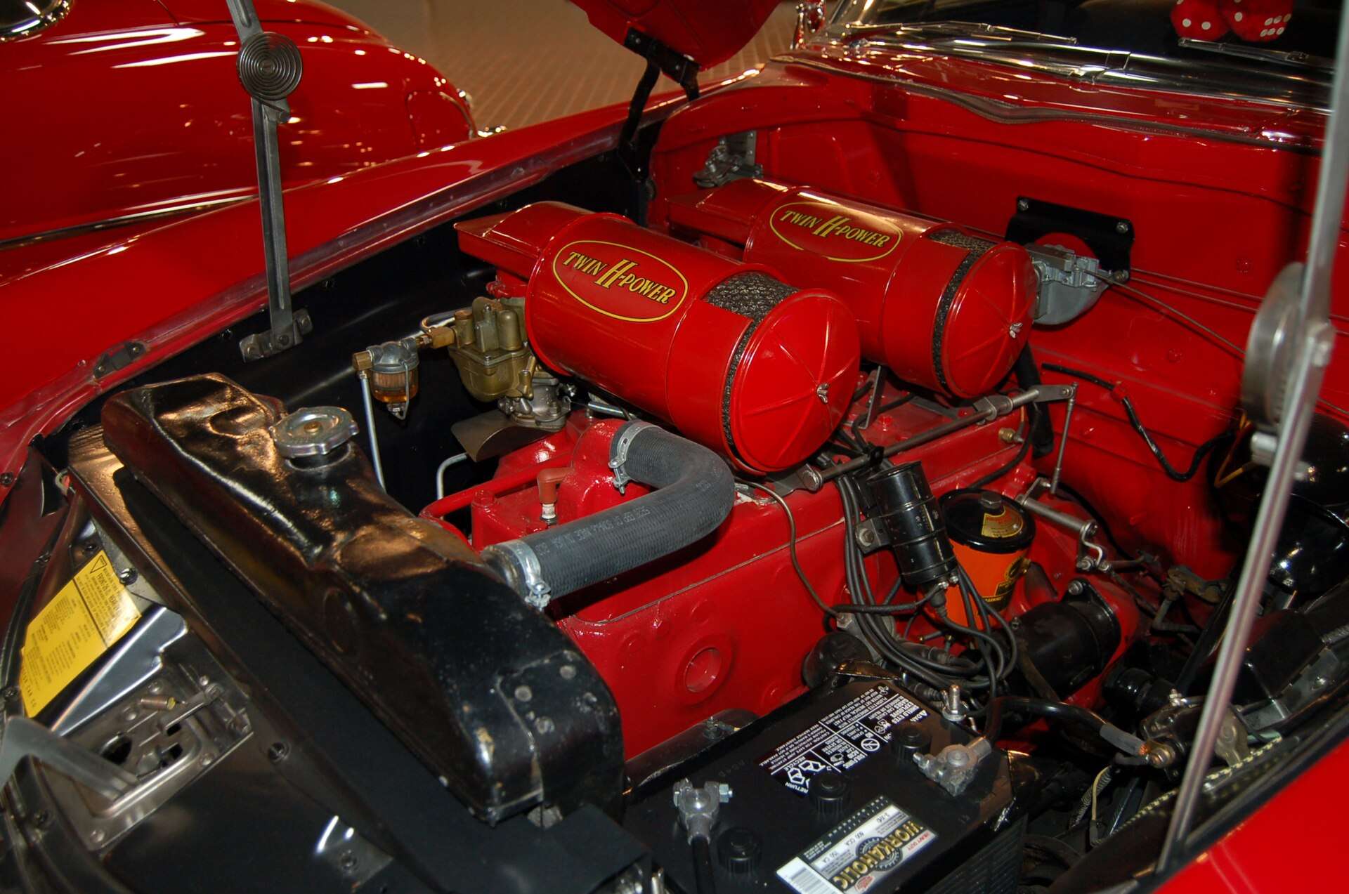 Red-painted 308 cubic-inch six-cylinder engine with dual carburetors in a 1954 Hudson Hornet Twin-H