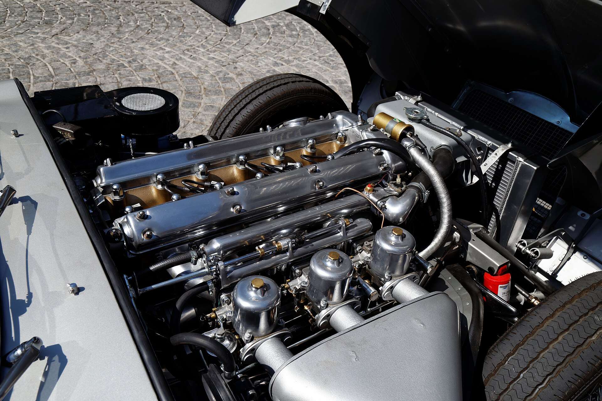 Chrome-finished 3.8-litre XK straight-six with triple SU carburetors in a 1962 E-Type engine bay