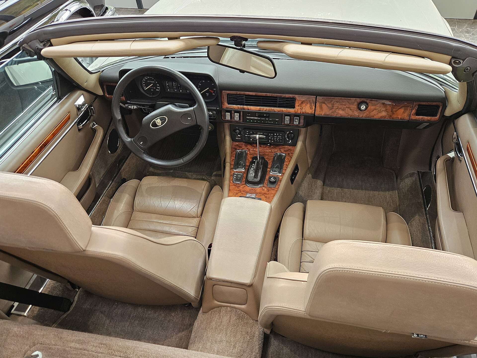 Interior of a Jaguar XJ-S convertible with wood veneer dash and leather seats