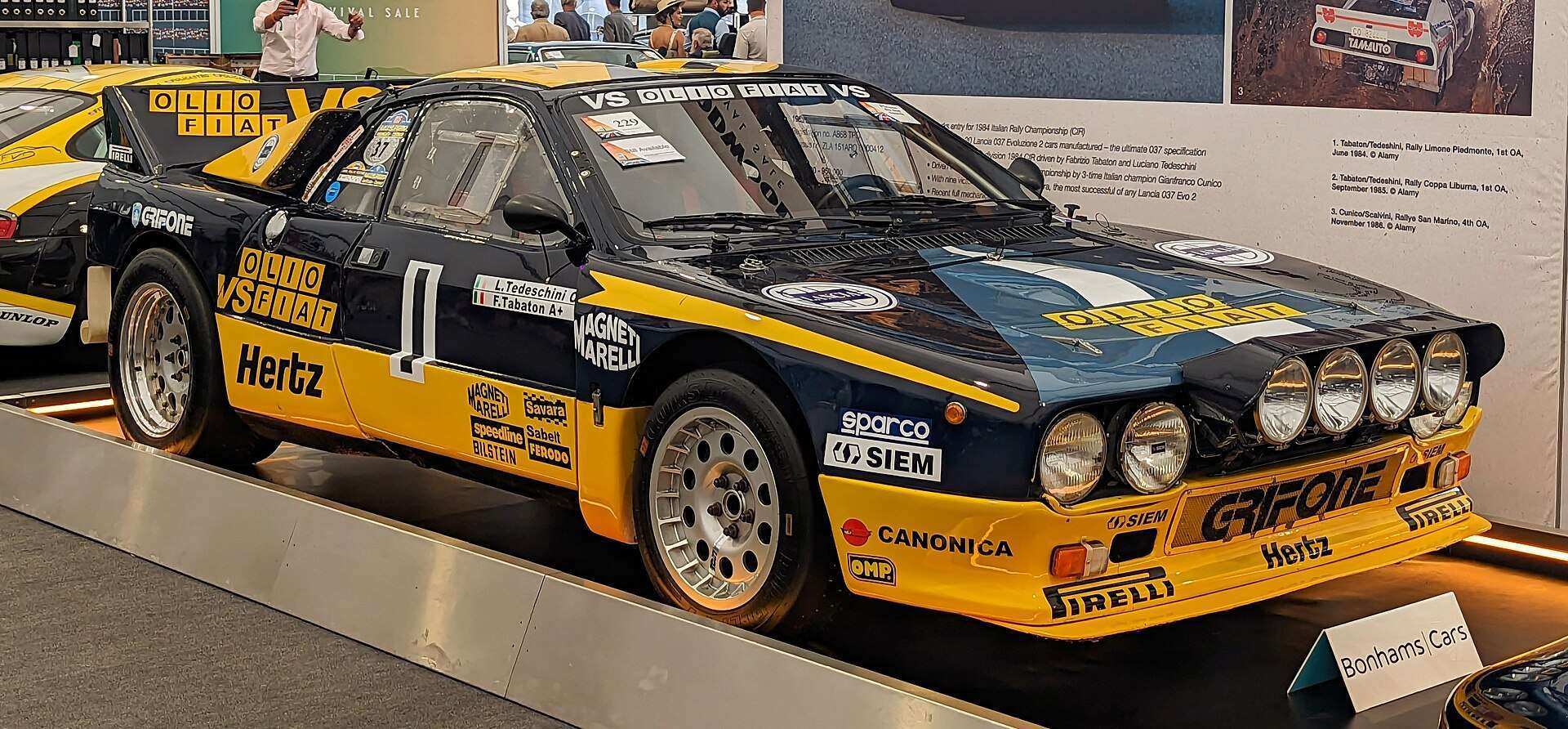 Lancia 037 Evo II rally car on display showing quad rally lights and Pininfarina-styled bodywork