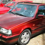 Is the Lancia Thema 8.32 a Future Collector Car? A Ferrari V8 Wrapped in an Executive Sedan Front three-quarter view of a burgundy Lancia Thema 8.32 sedan with five-spoke alloy wheels and a sunroof