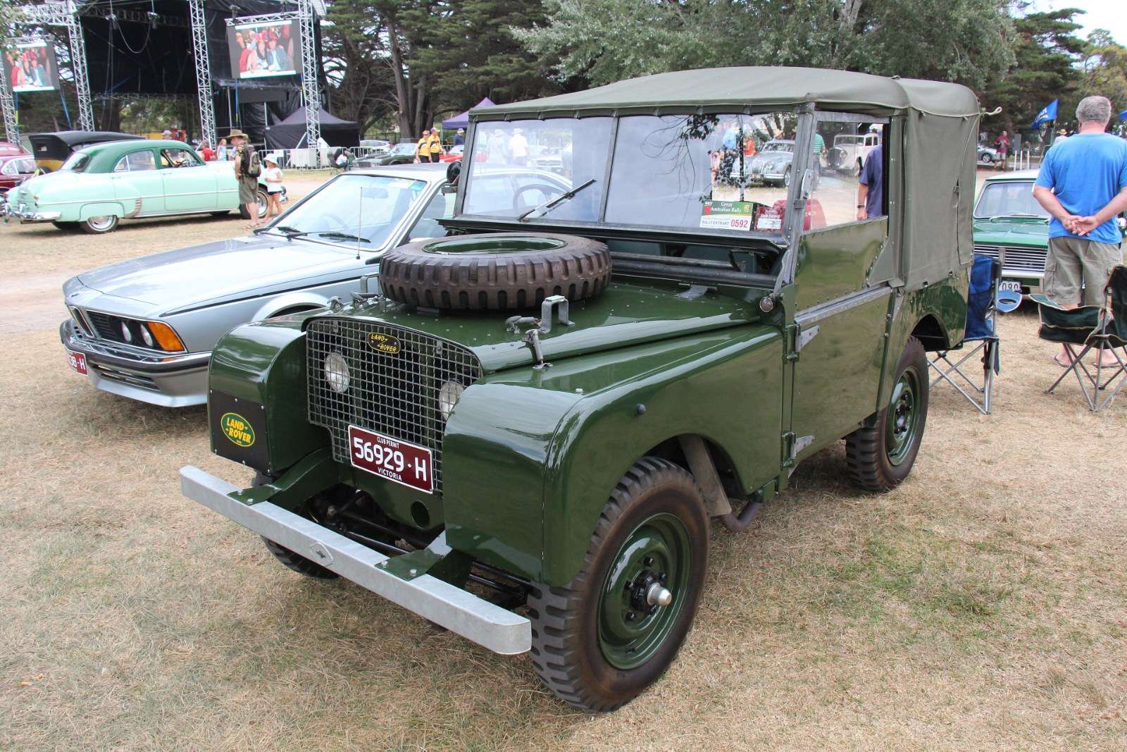Green 1948 Land Rover Series I 80-inch with canvas top, spare wheel on the bonnet and headlamps set behind the galvanized grille