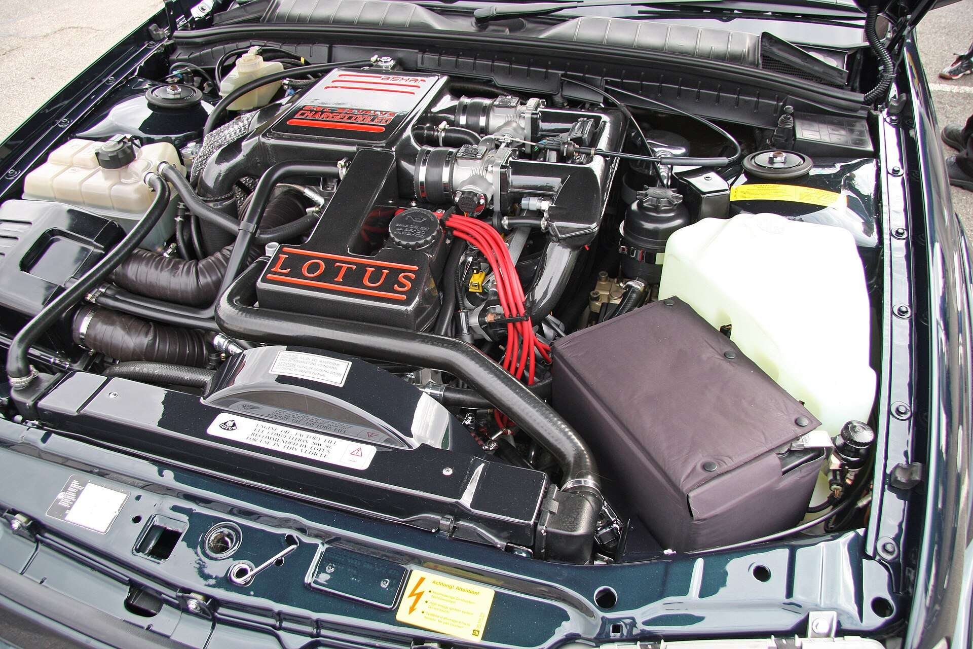 Engine bay of a Lotus Carlton with the Lotus-branded cam cover on the 3.6-litre twin-turbo inline-six