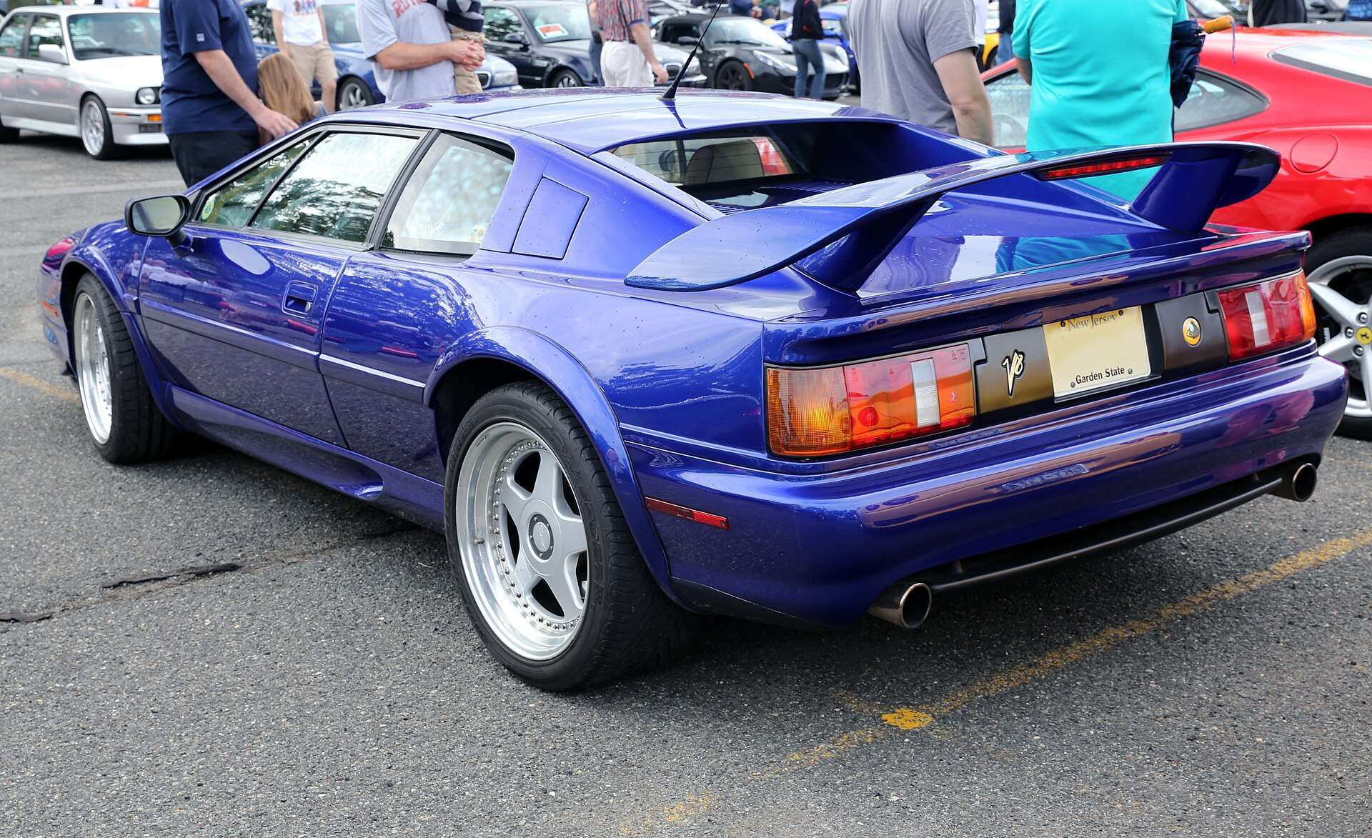 Rear three-quarter view of a purple 1998 Lotus Esprit V8 showing the large rear wing and twin tail lamps