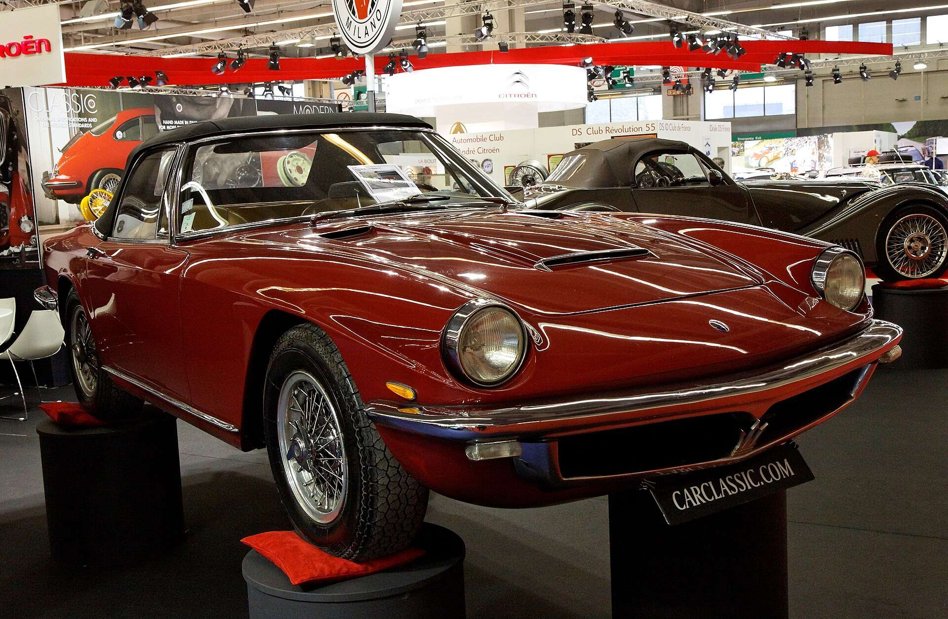 Dark red Maserati Mistral Spider 3.7 convertible with chrome bumpers on display at Rétromobile in Paris