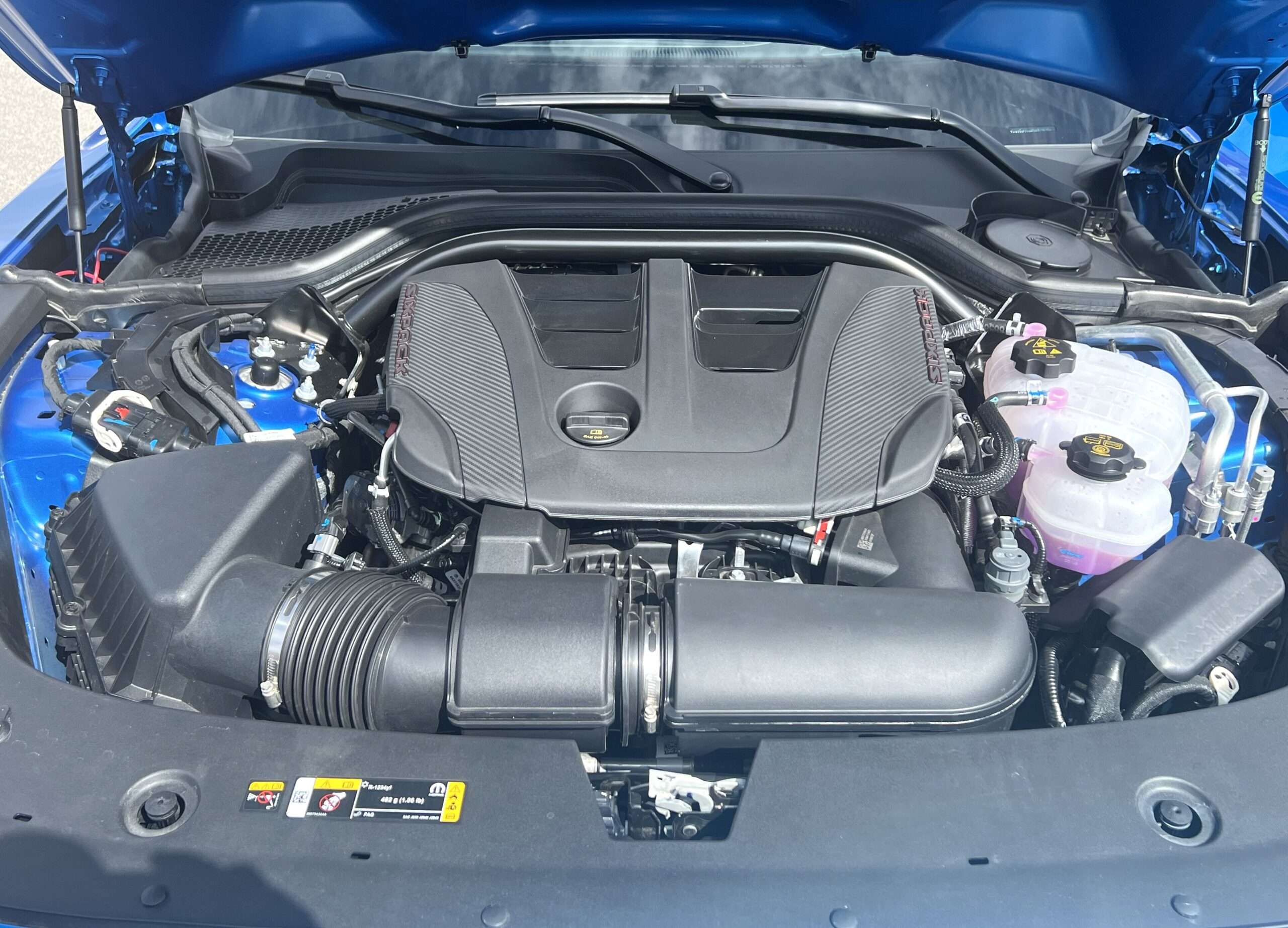 Twin-turbo 3.0-liter inline-six Hurricane engine under the hood of a 2026 Dodge Charger