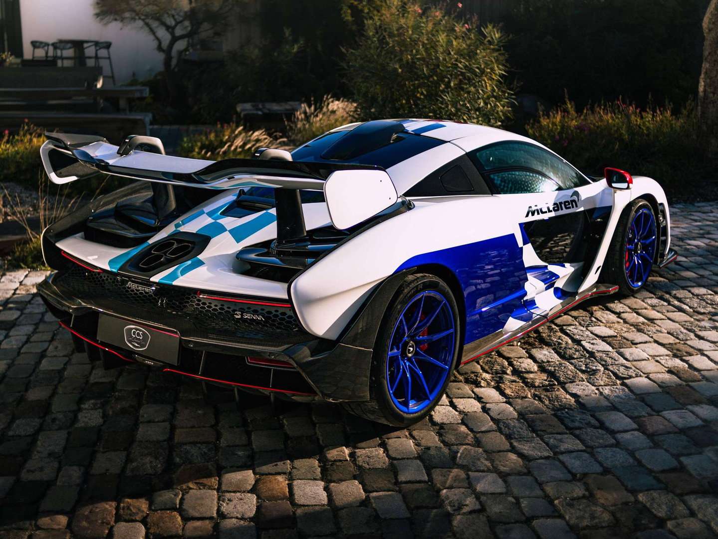 Rear three-quarter view of McLaren Senna Fina showing blue livery and rear wing