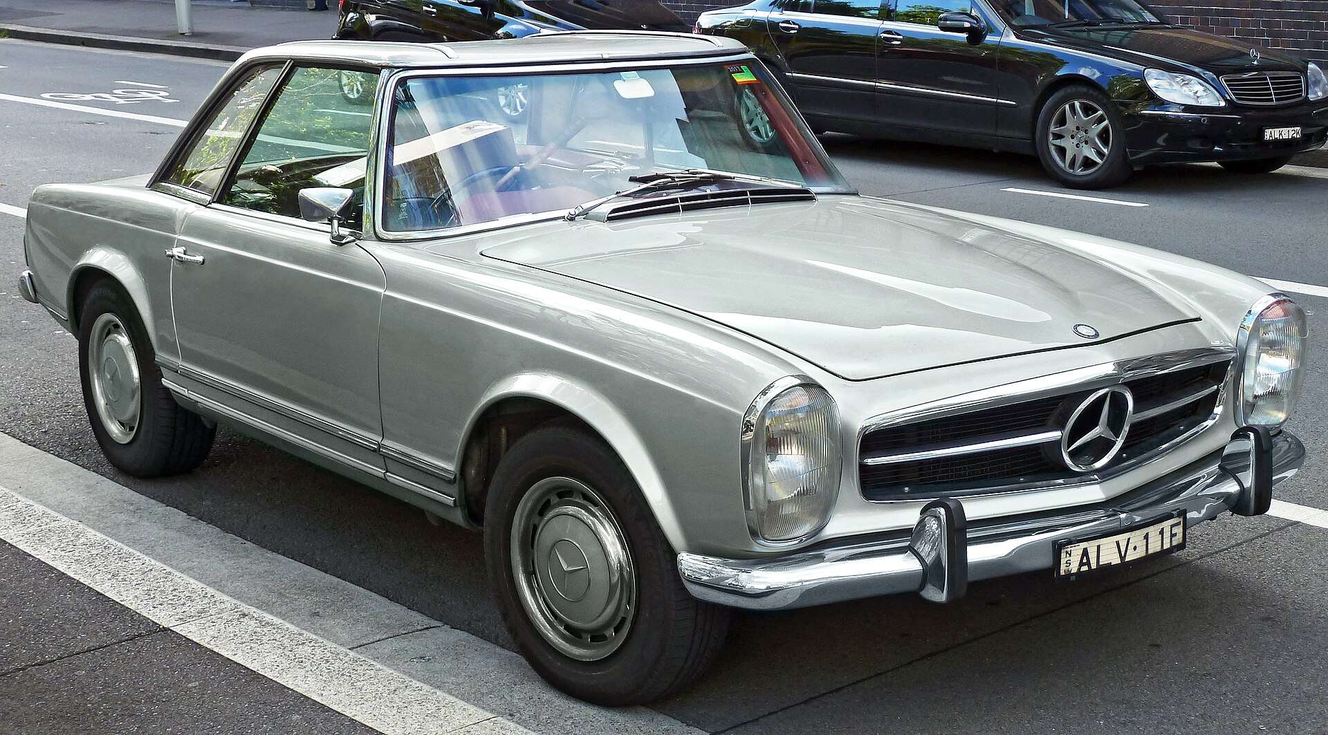 Silver 1969 Mercedes-Benz 280 SL W113 with hardtop parked on a city street