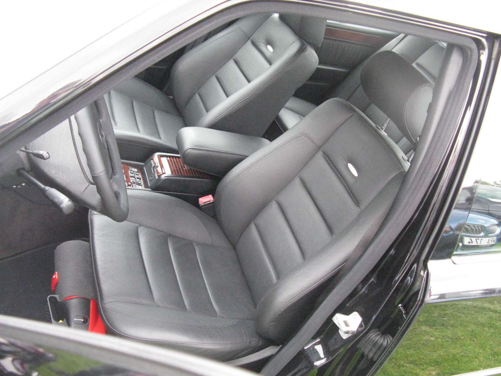 Gray leather front seats and dashboard inside a Mercedes-Benz 500E