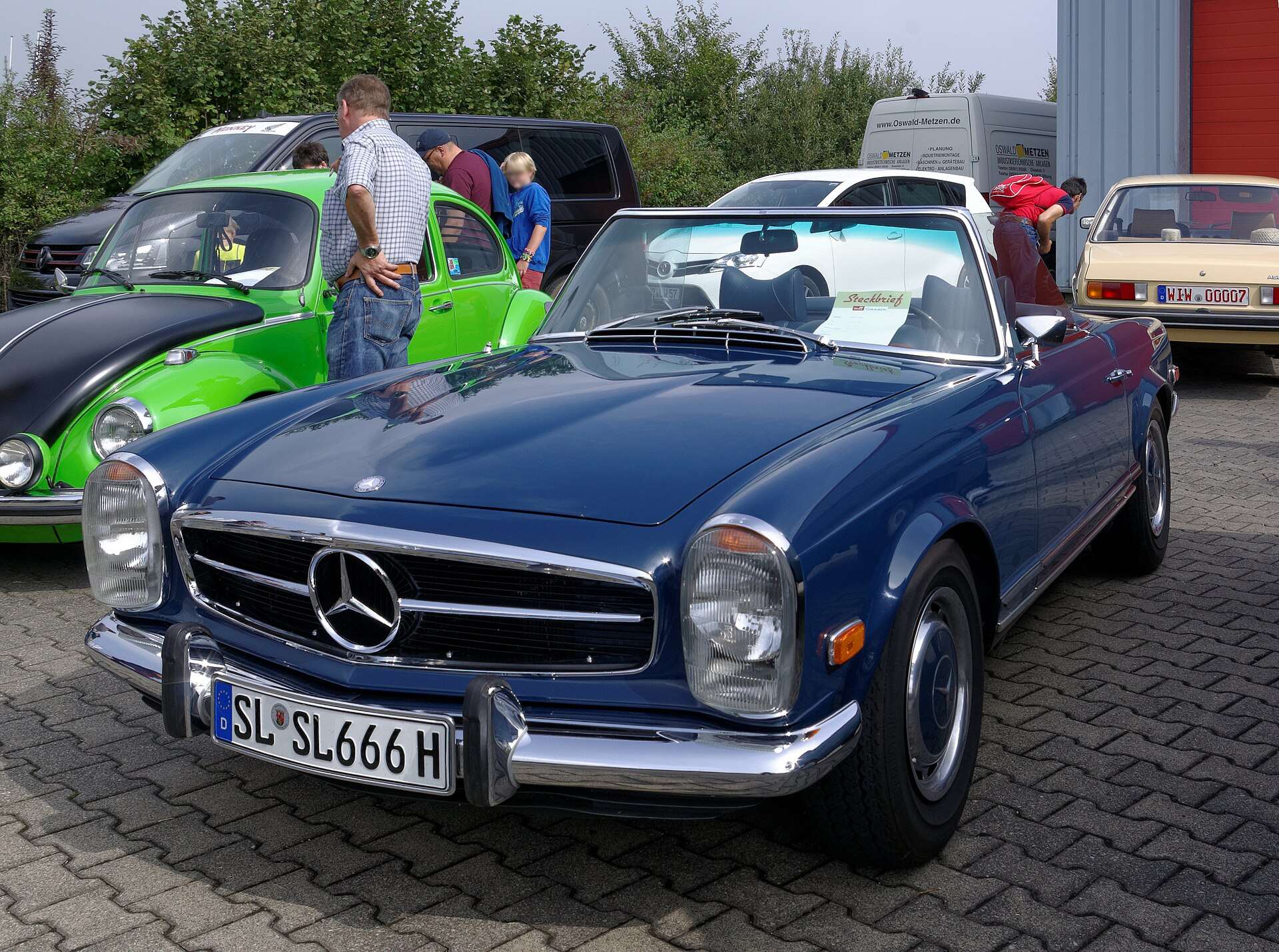 Dark blue Mercedes-Benz W113 280 SL roadster at a classic car meeting