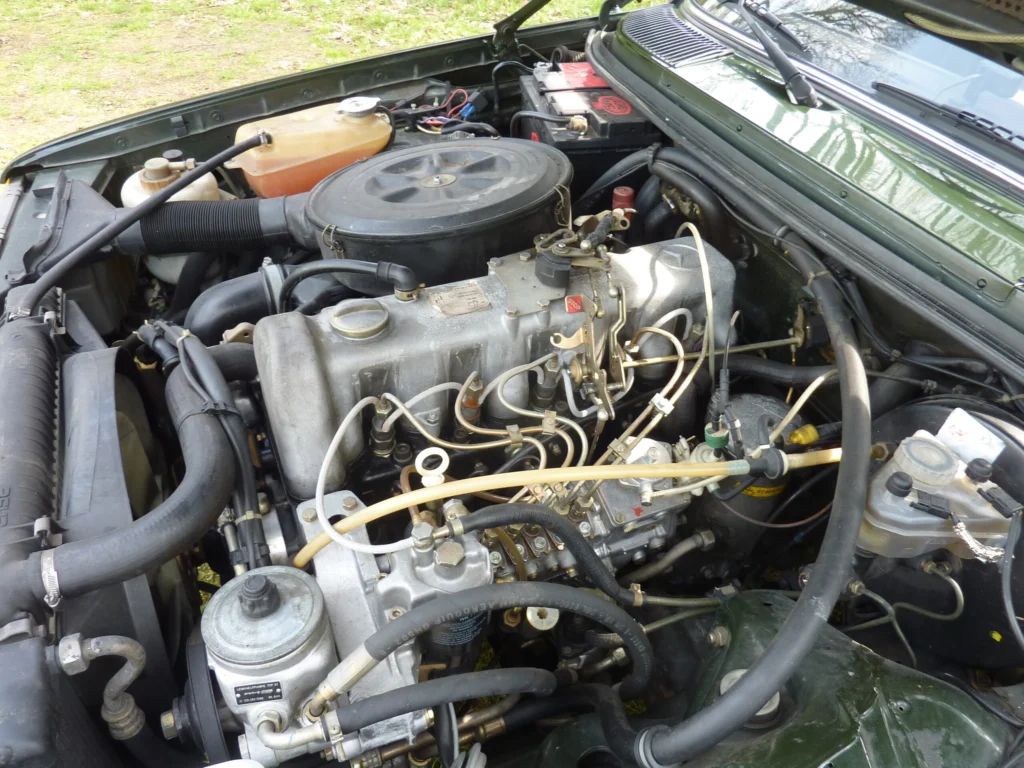 Engine bay of a 1983 Mercedes-Benz W123 300 TDT wagon showing the five-cylinder turbodiesel and its fuel injection lines