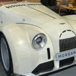 Is the Morgan Midsummer Coupe a Future Collector Car? Ten Cars, a Wooden Frame, and No Published Price Morgan Midsummer roadster in white on display, the car on which the Midsummer Coupe is based