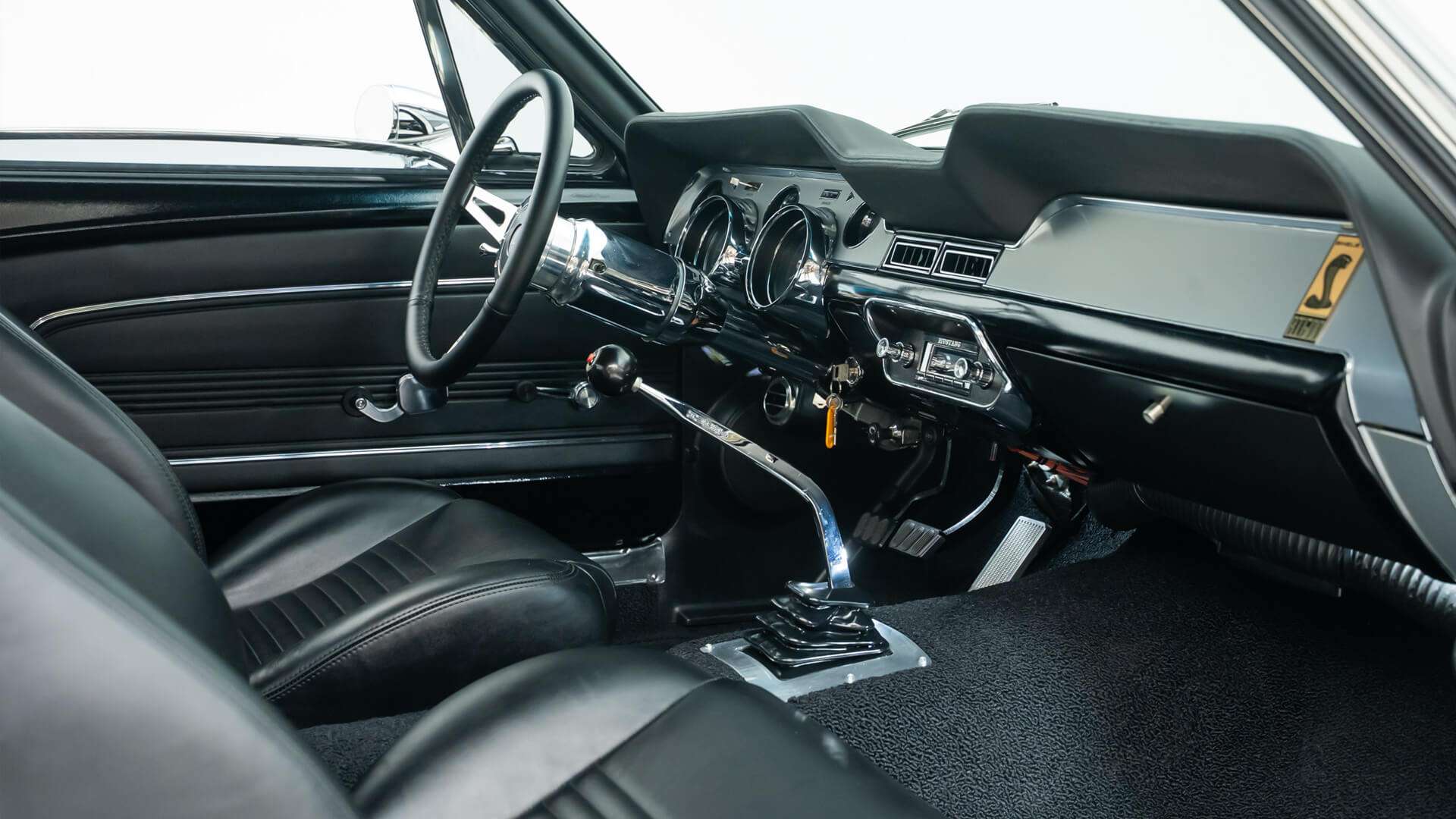 Black interior with polished shifter and tilt column in the 1968 Mustang restomod