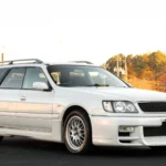 White 1998 Nissan Stagea 260RS Autech Version wagon in front three-quarter view with roof rails and deep front valance