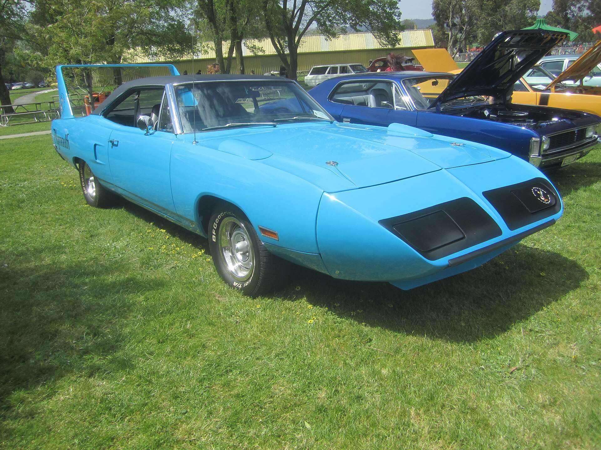 1970 Plymouth Superbird nosecone and pop-up headlight covers at a car show