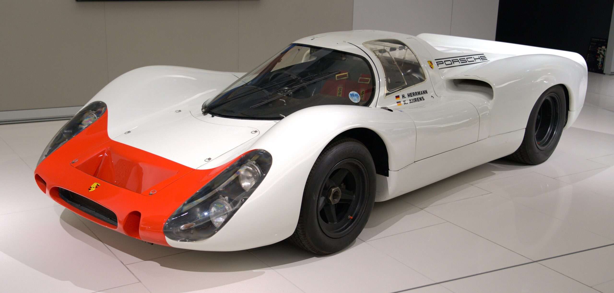 White 1969 Porsche 908 prototype race car with orange nose on display in the Prince of Monaco car collection