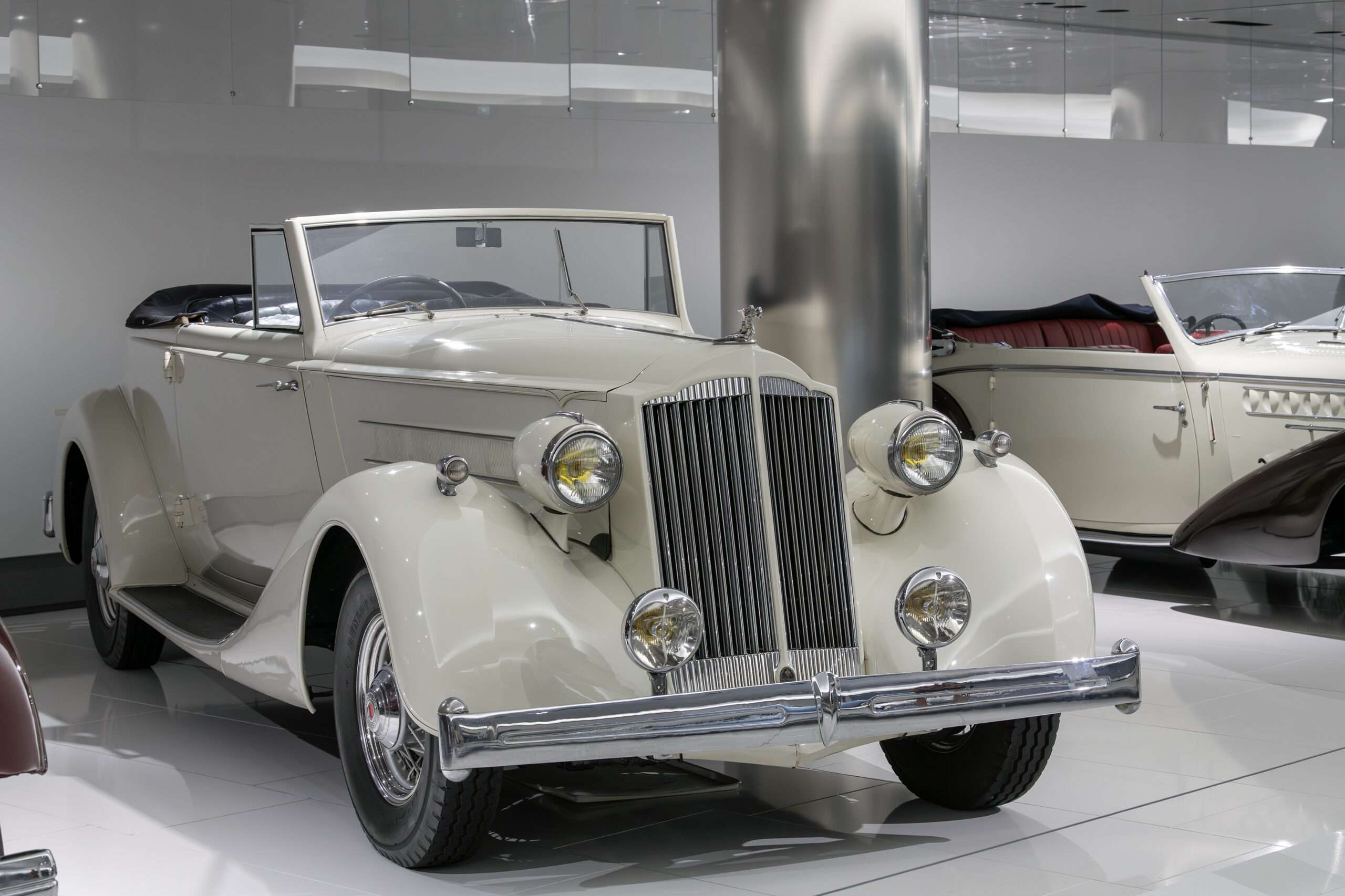 White Packard Super Eight Convertible Victoria with chrome grille and fender lamps in the Prince of Monaco car collection