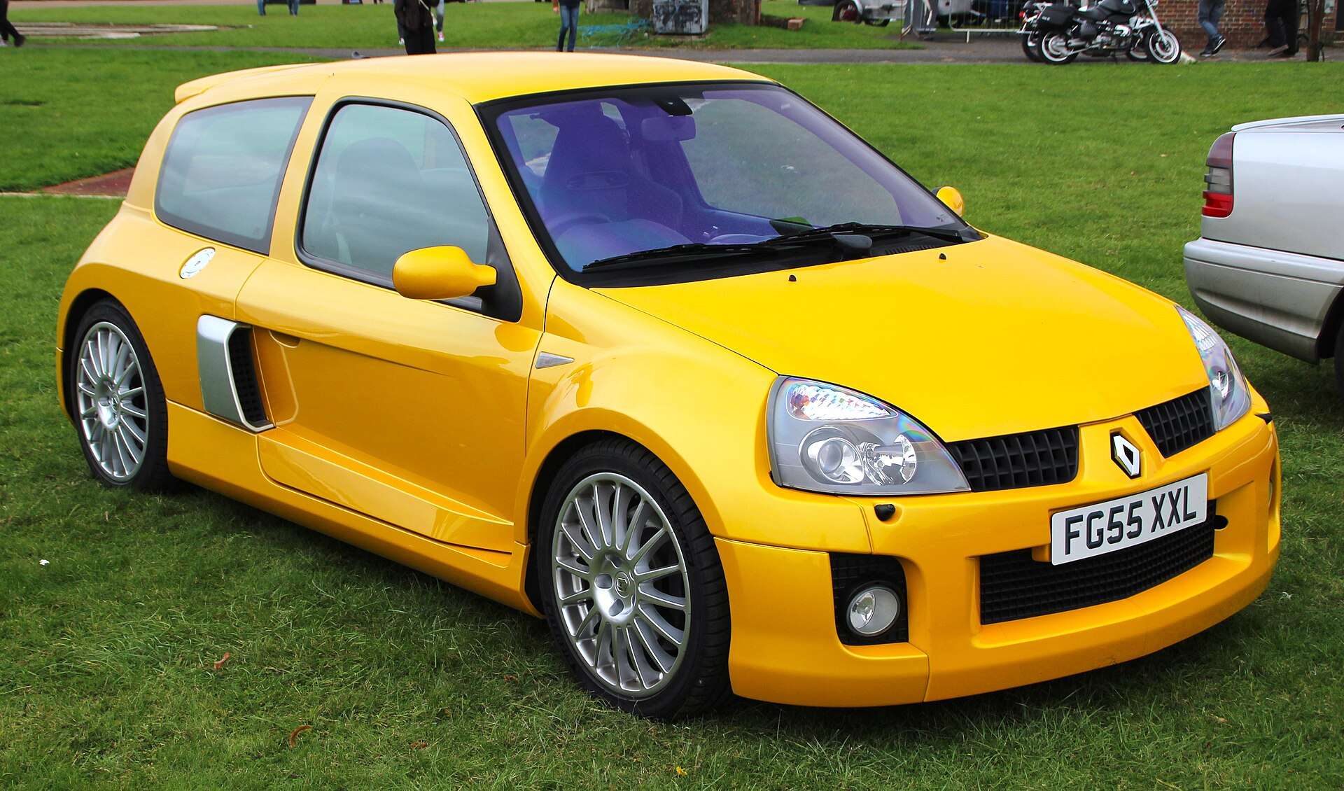 Yellow 2005 Renault Clio V6 Phase 2 parked on grass at a car show